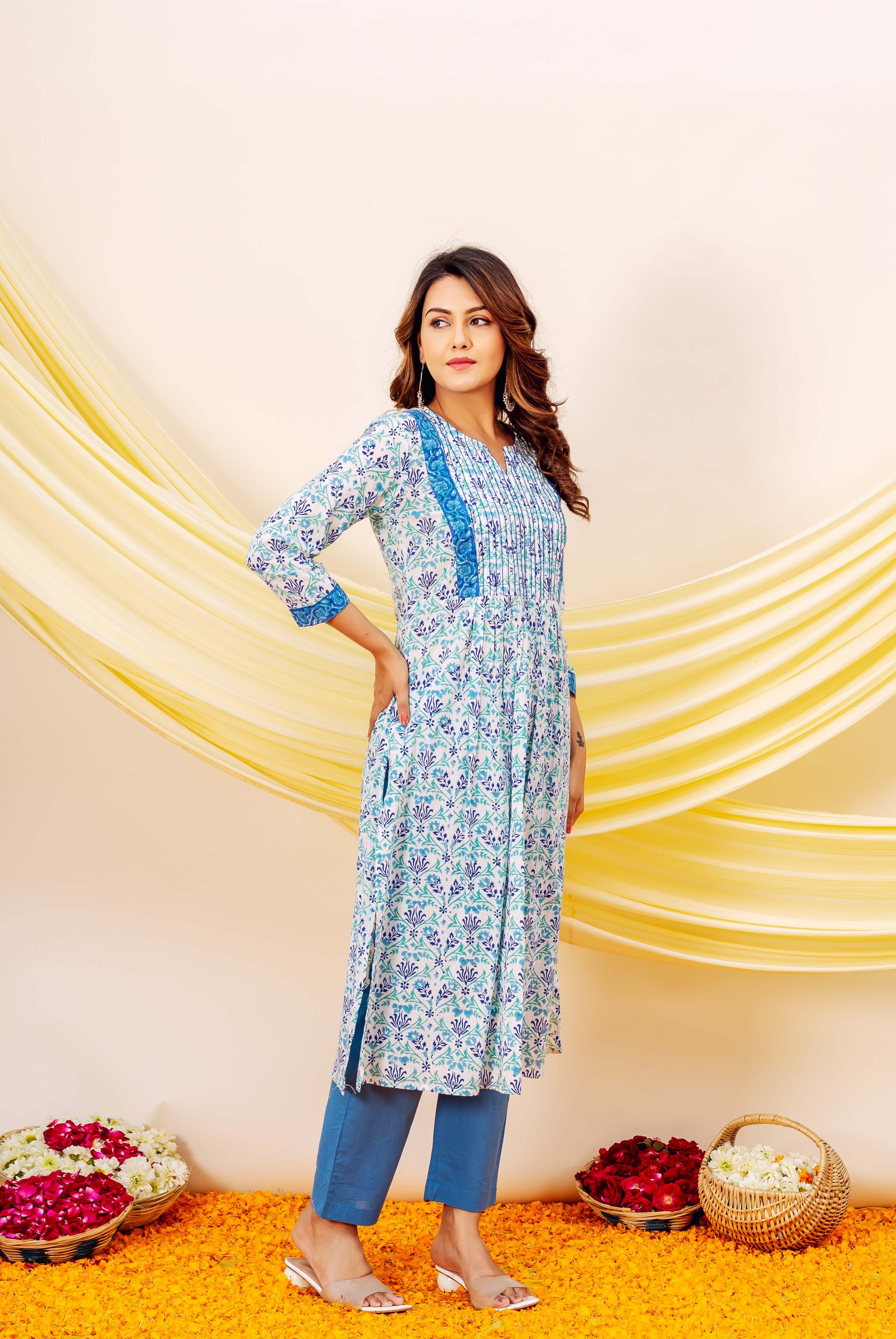 Woman modelling a white and blue misprint hand-block printed cotton kurta and blue pants.