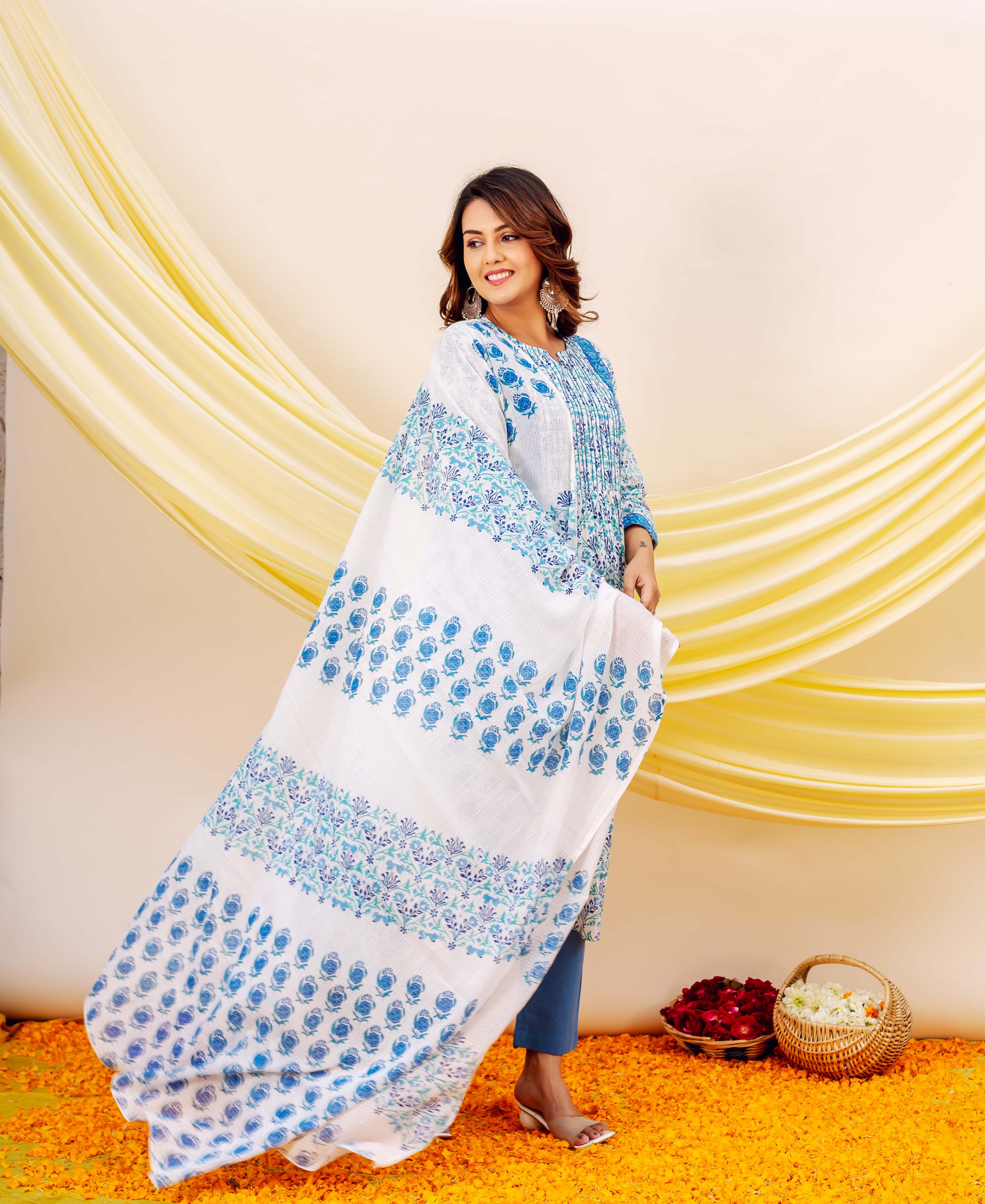 White and blue hand-block-printed Kota Doriya dupatta with floral pattern on woman.