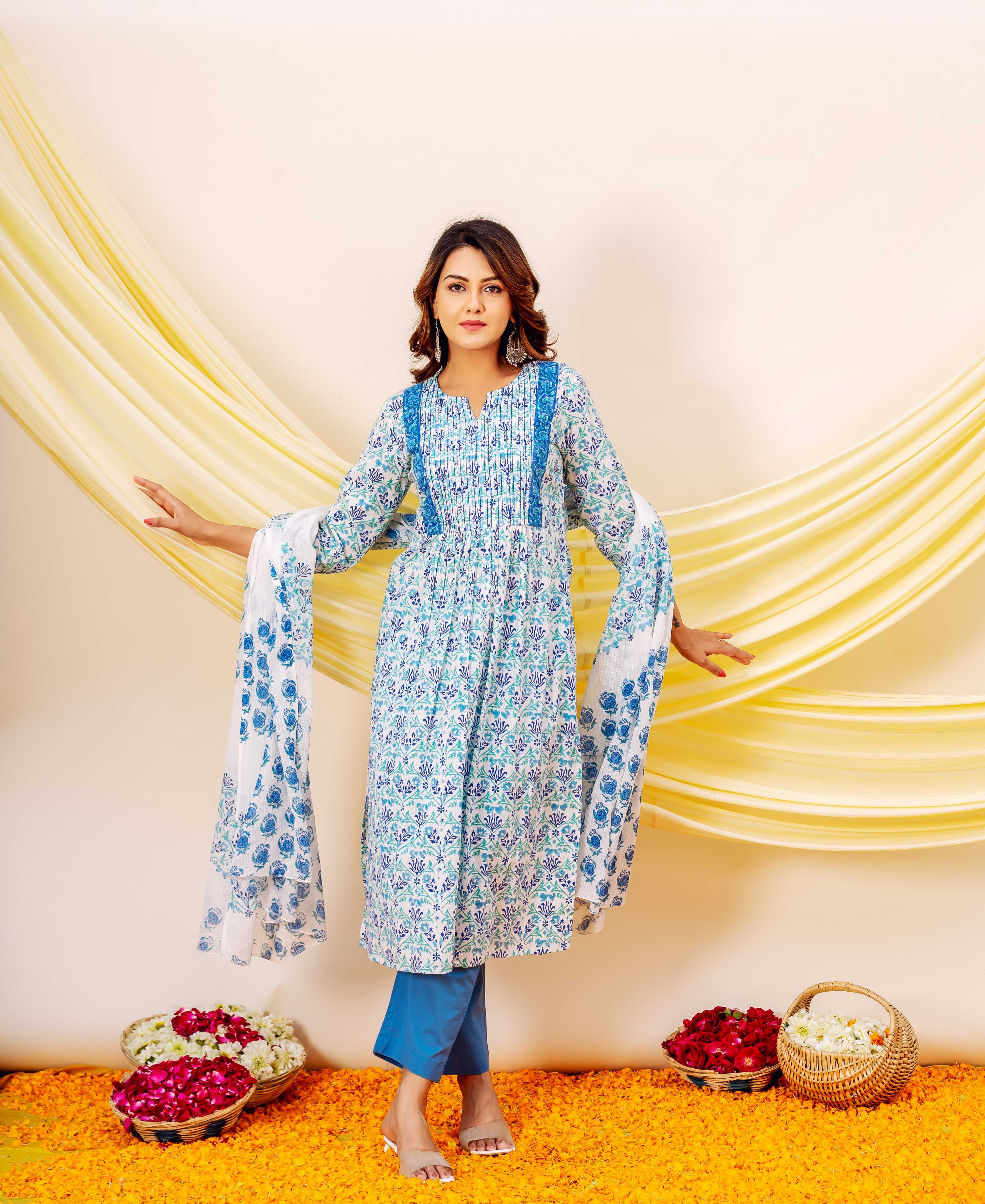 Model wears white and blue floral block-printed dupatta over a matching kurti and blue pants.