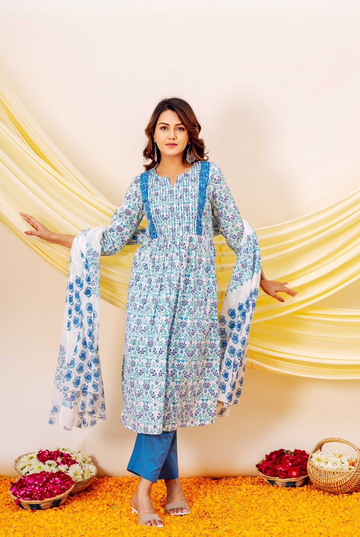 Model wears a blue and white hand-block printed cotton kurta, matching dupatta, and blue pants.
