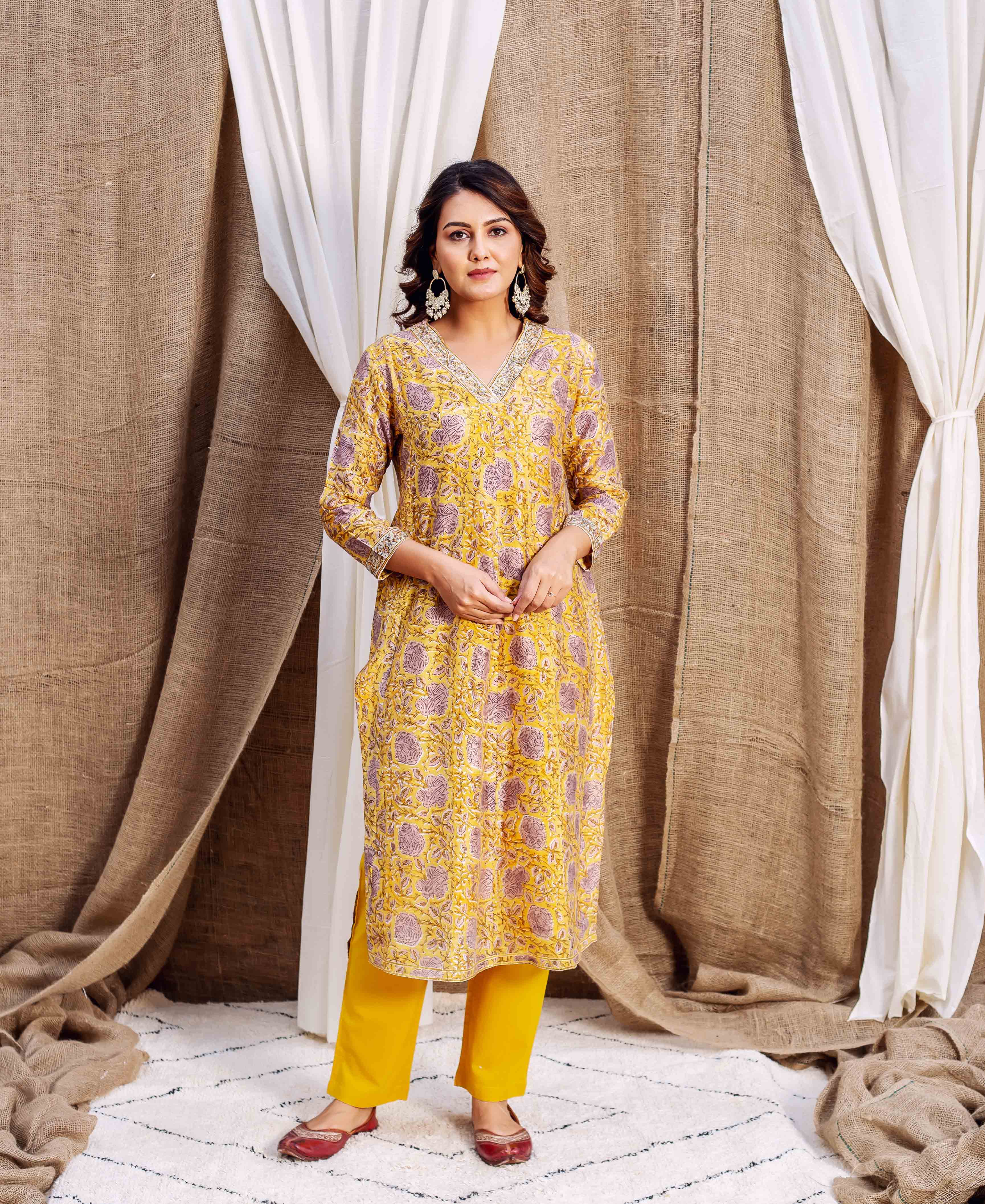Full shot of model in yellow floral block-printed chanderi kurta and matching pants.