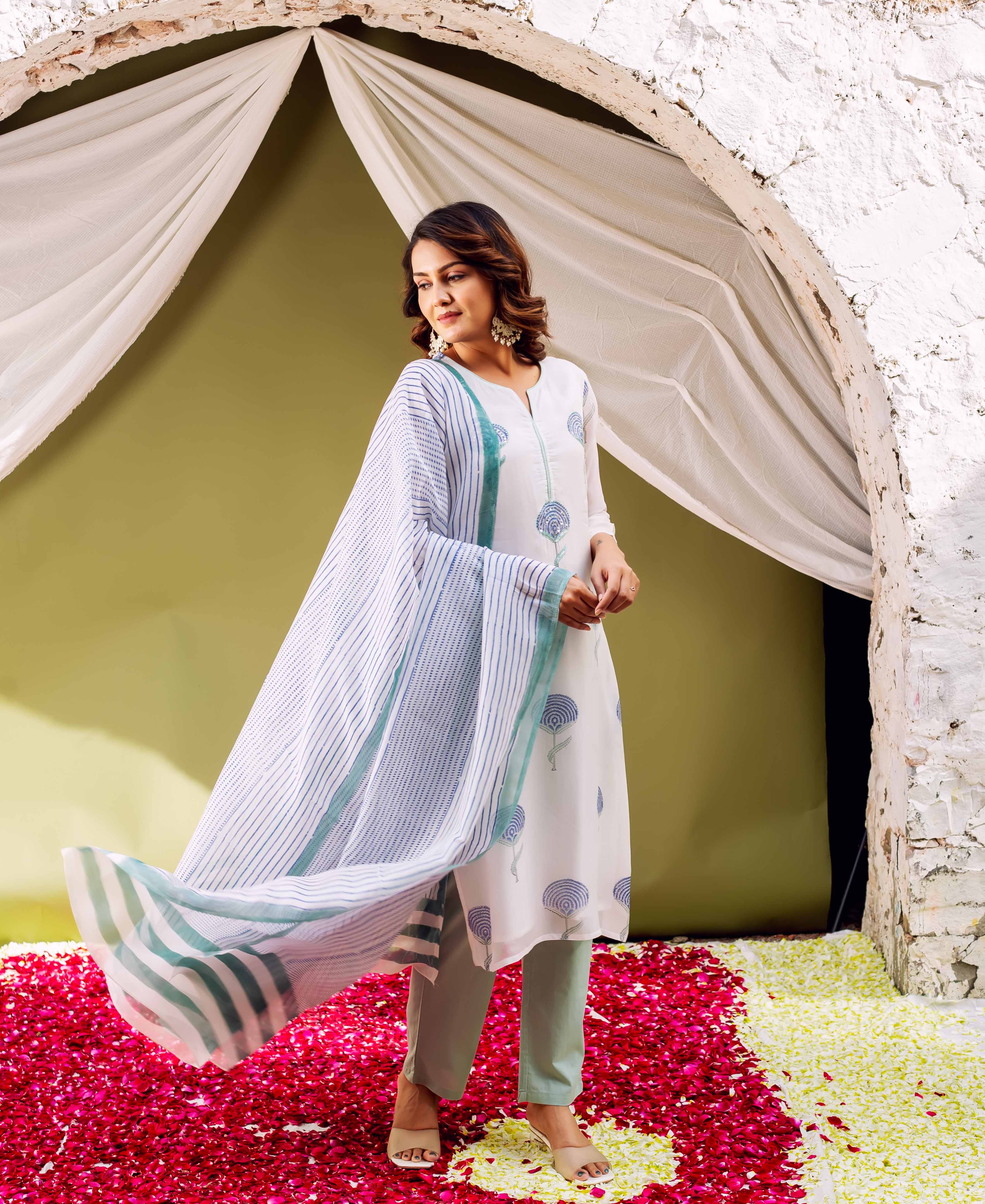 Model wears a white hand-block printed organza kurta with blue floral motifs.