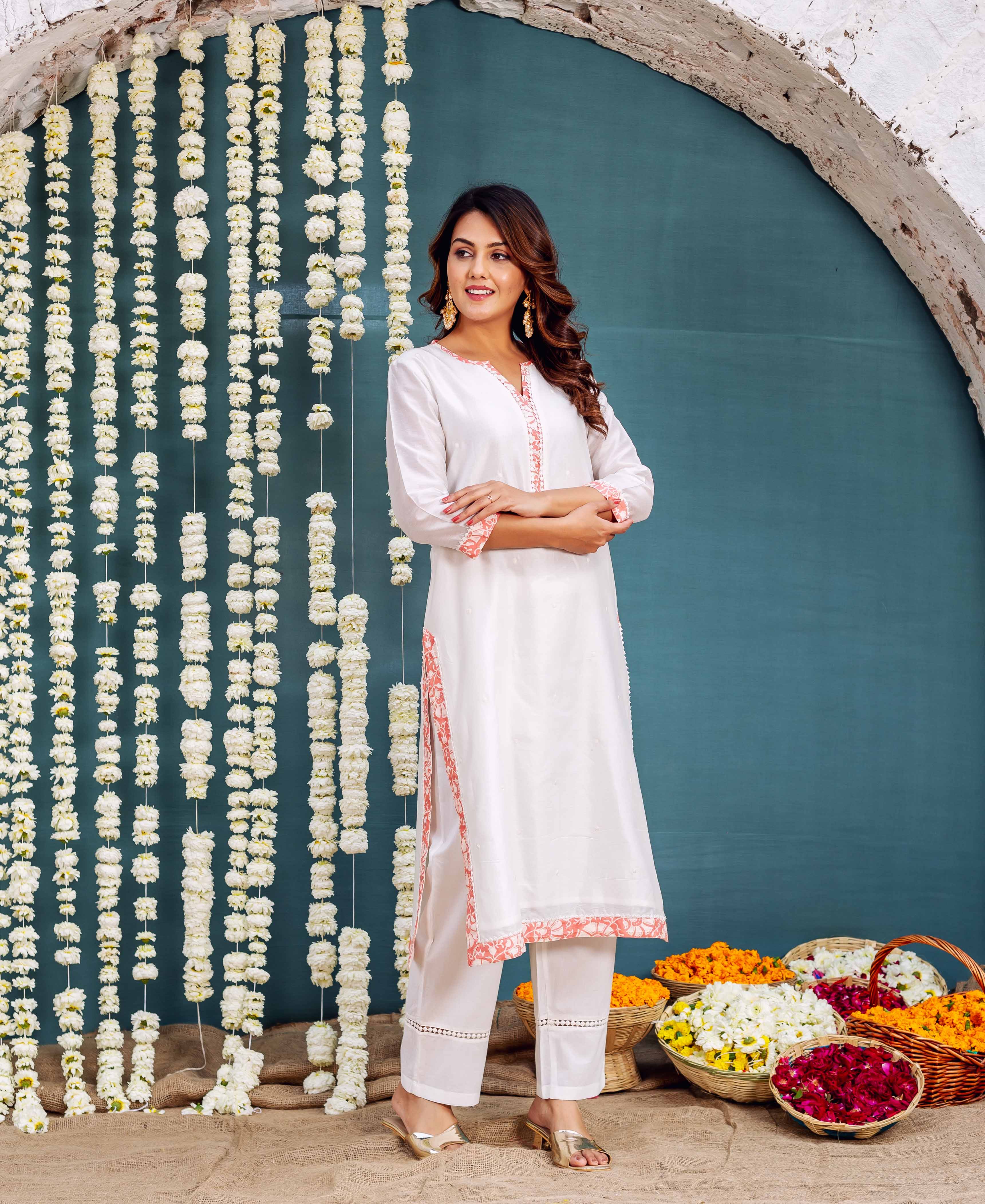 Front view standing model in white Chanderi kurta set with peach hand-block print.