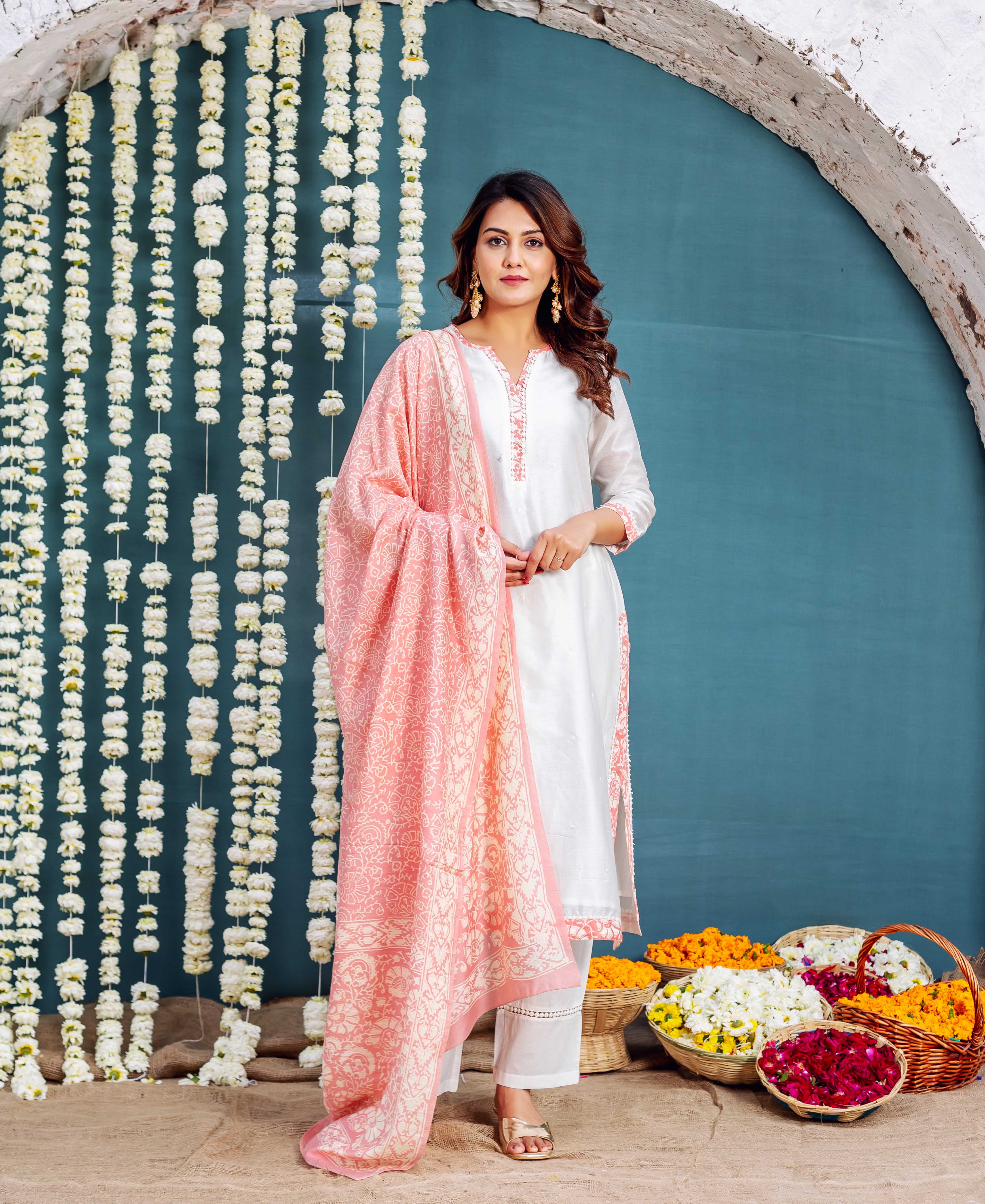 Front full look of model in white kurta set with pink floral hand-block printed dupatta.