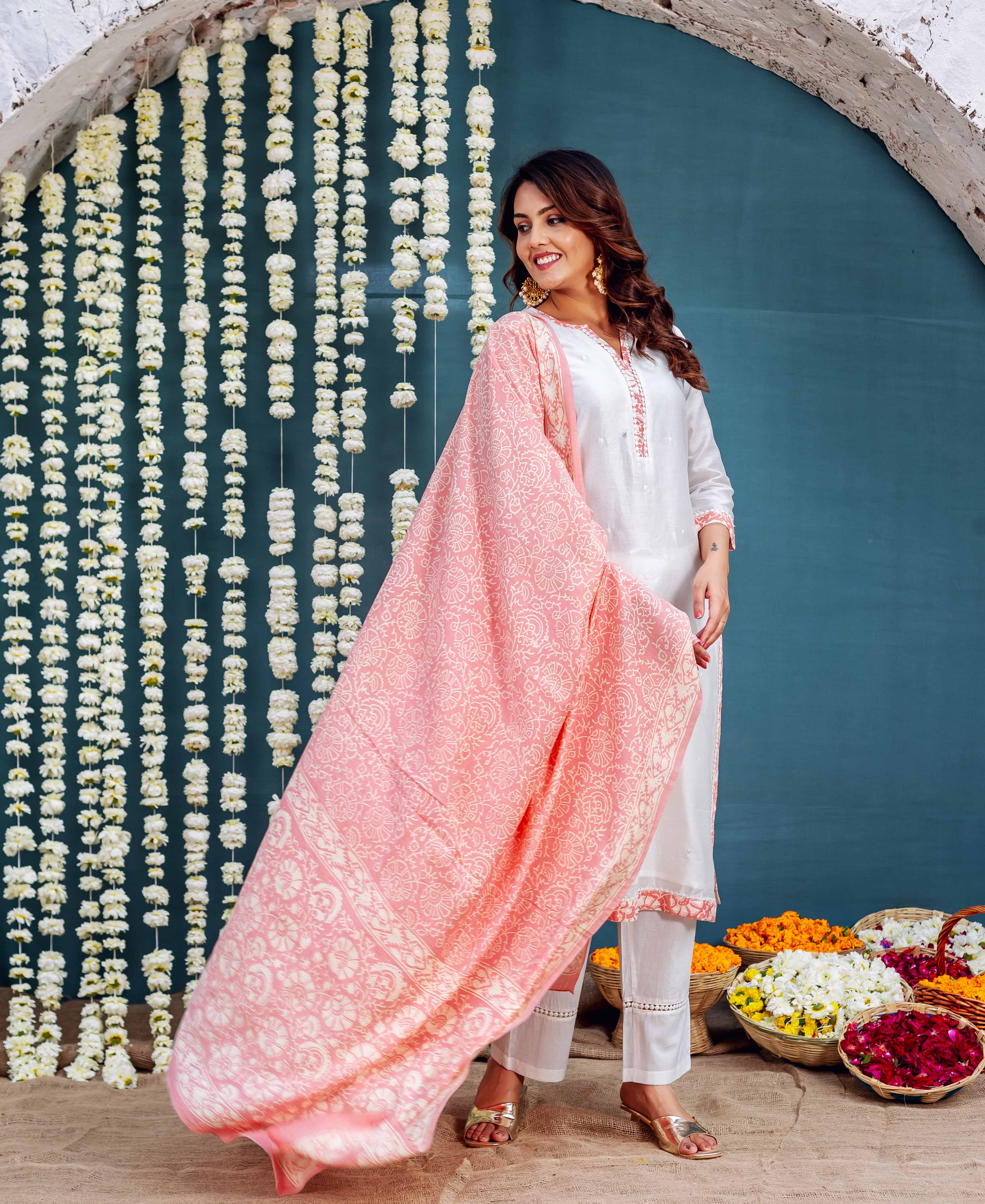 Model in white Chanderi kurta set with a flowing pink blossom hand-block-printed dupatta.
