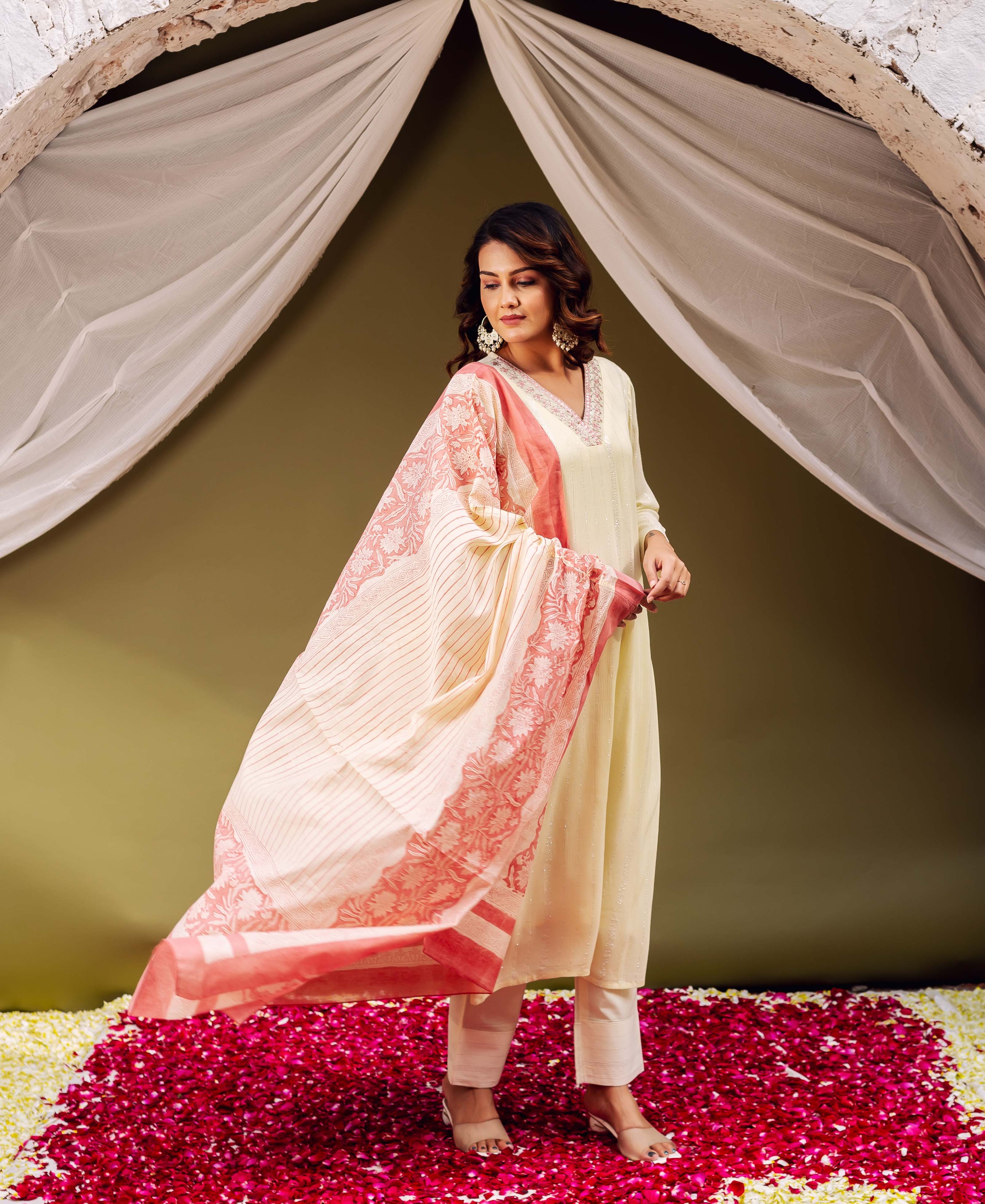 Model displays a flowing cream dupatta with vibrant red hand-block printed stripes and motifs.