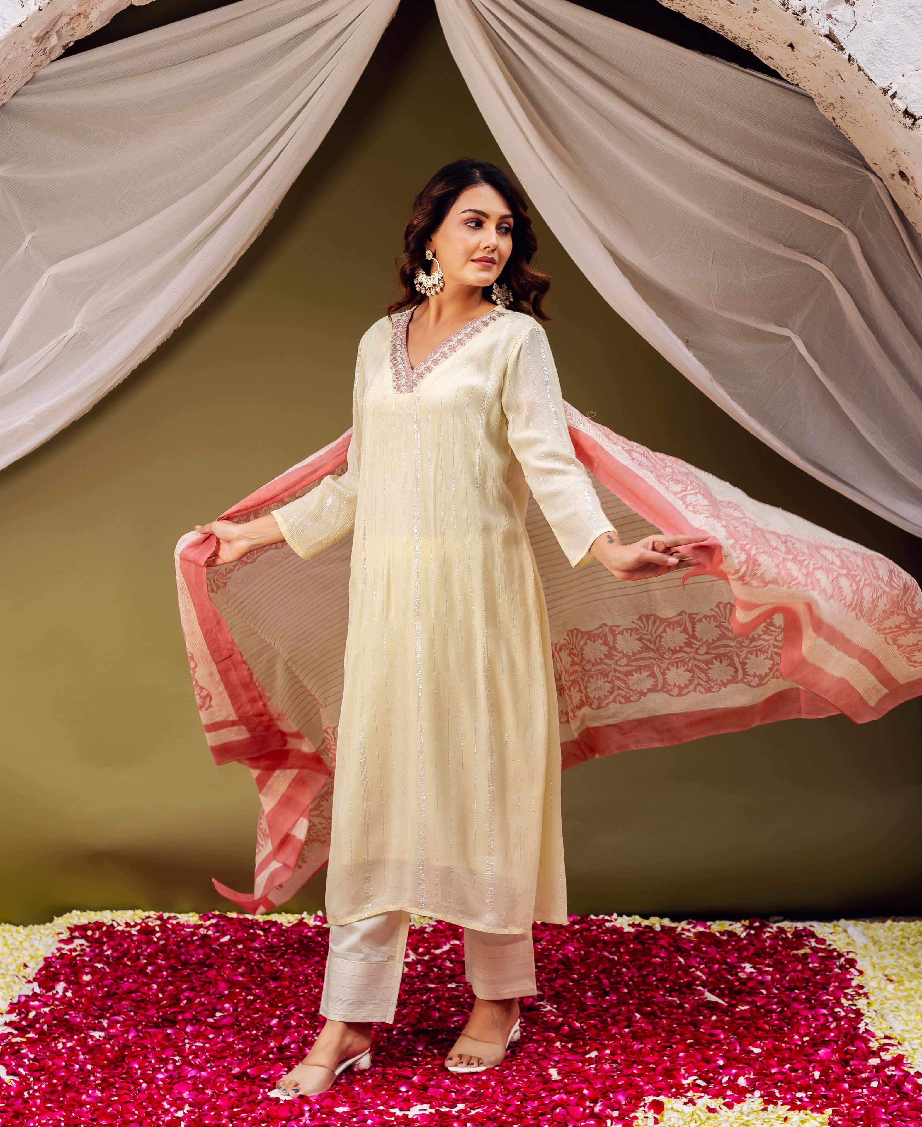 Model holds a red hand block printed chanderi dupatta with striped cream base, over a kurta set.
