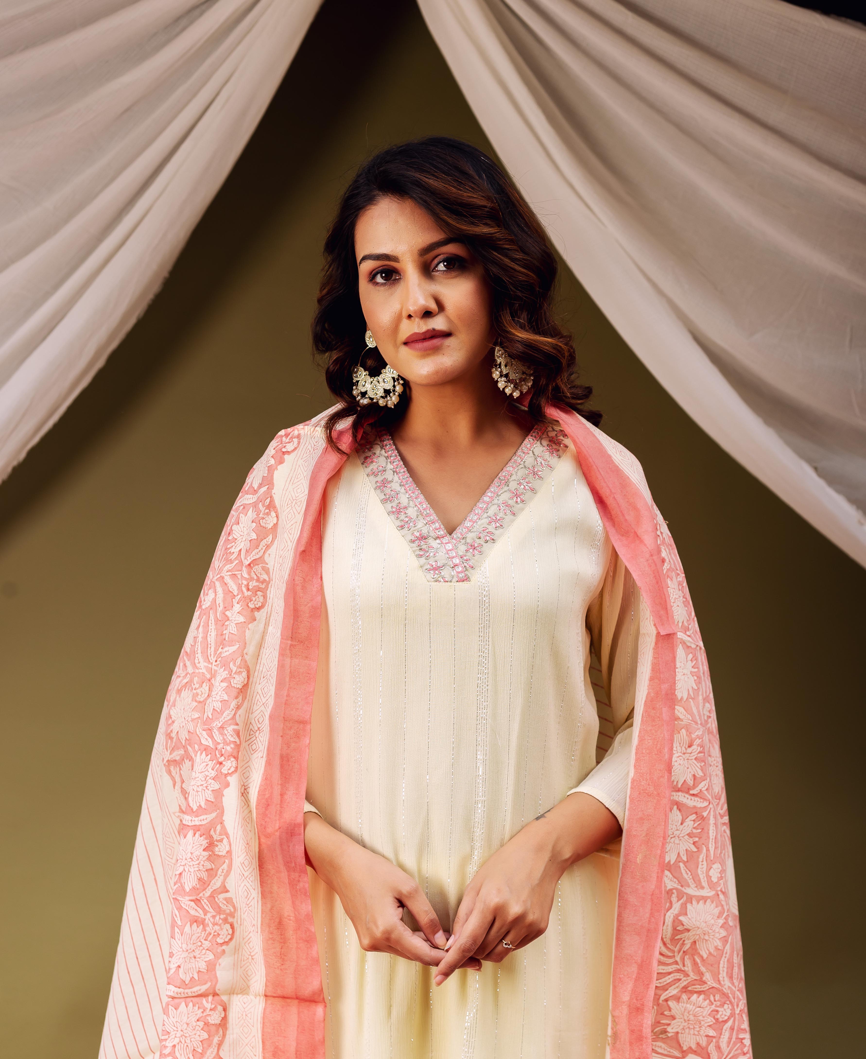 Front view of model wearing cream and coral hand block printed dupatta with floral and striped patterns.
