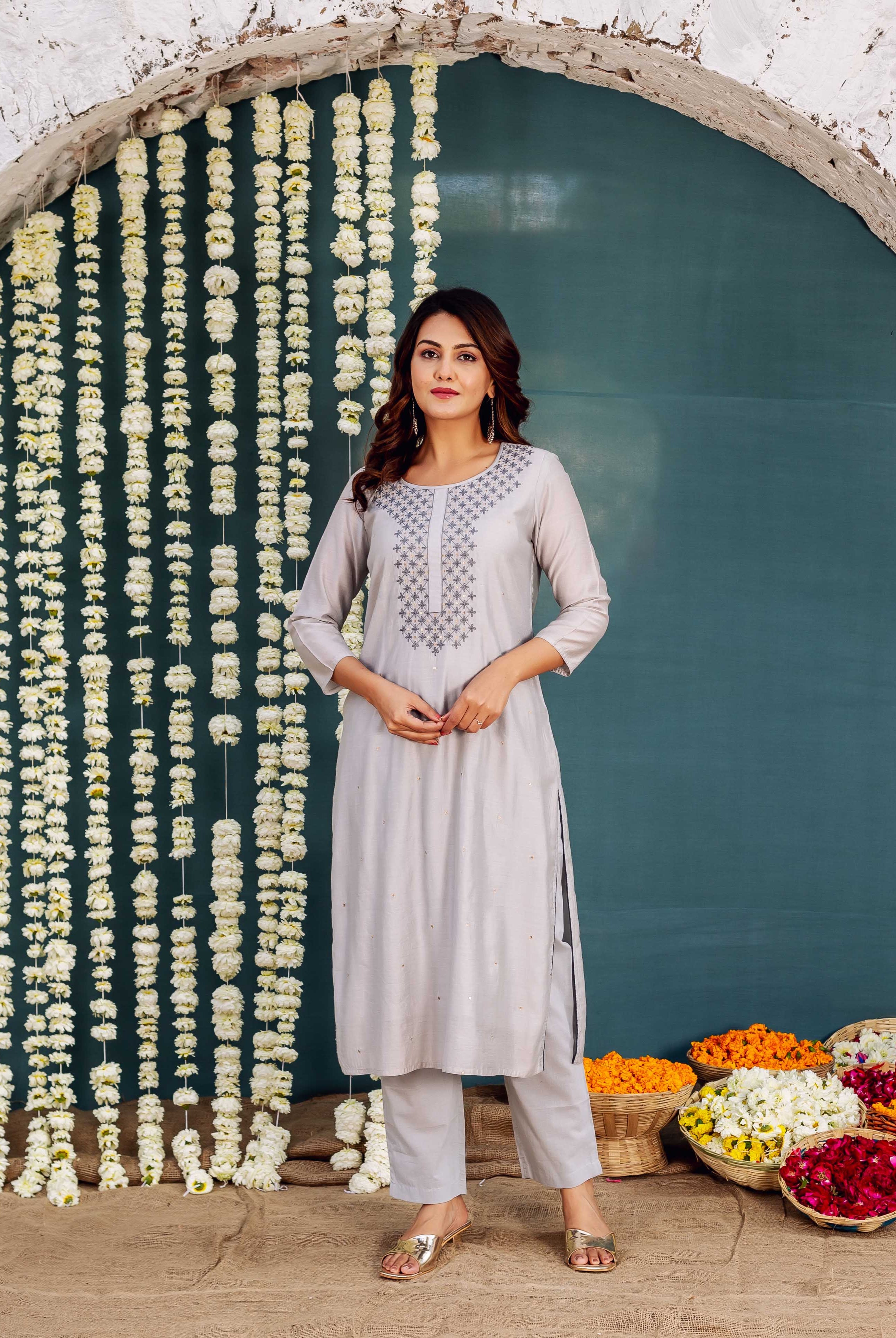 Full shot of model wearing Zara grey embroidered kurta with geometric neckline design.