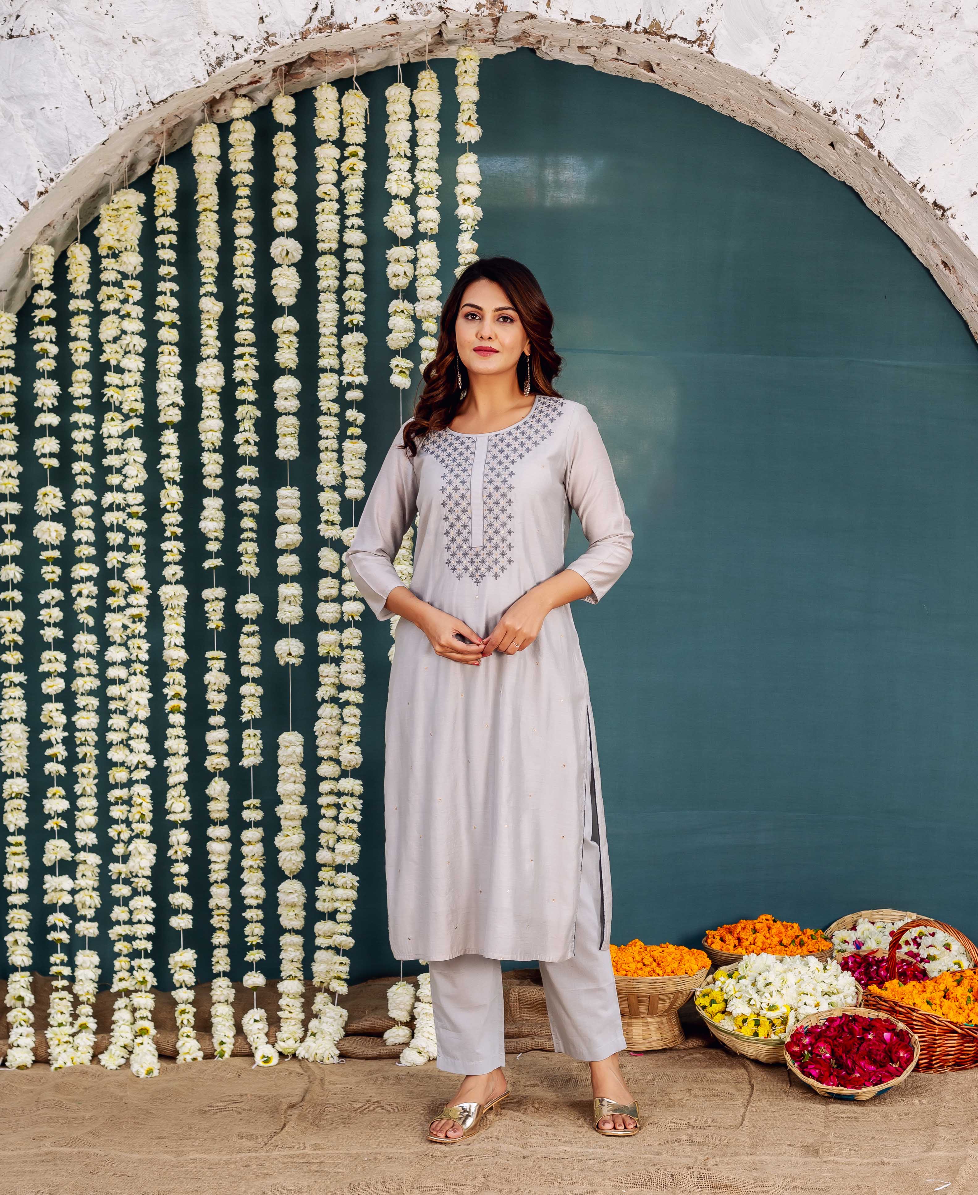 Full shot of model wearing Zara grey embroidered kurta with geometric neckline design.