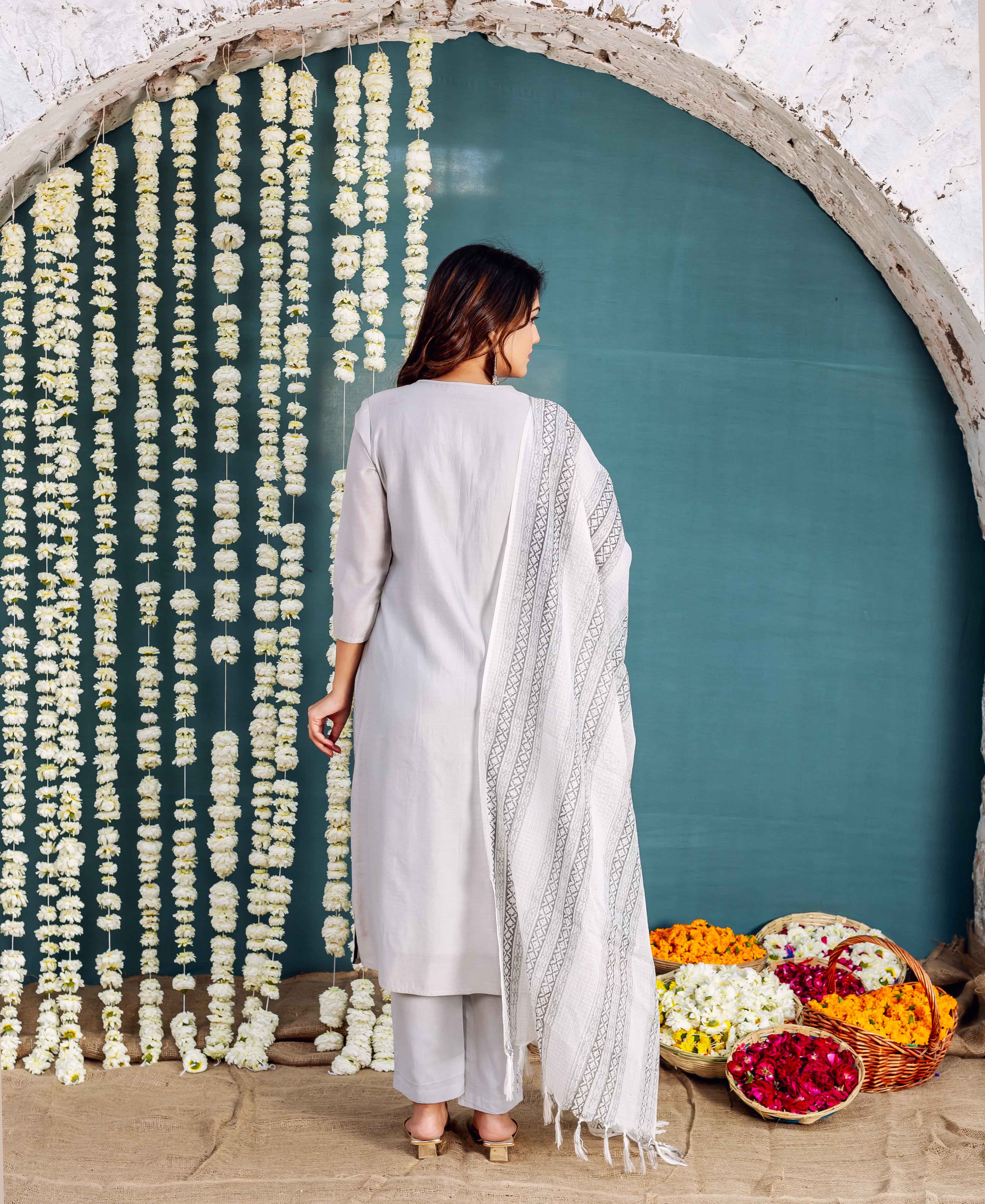 Back view of a model wearing a simple grey kurta with a white geometric printed dupatta.
