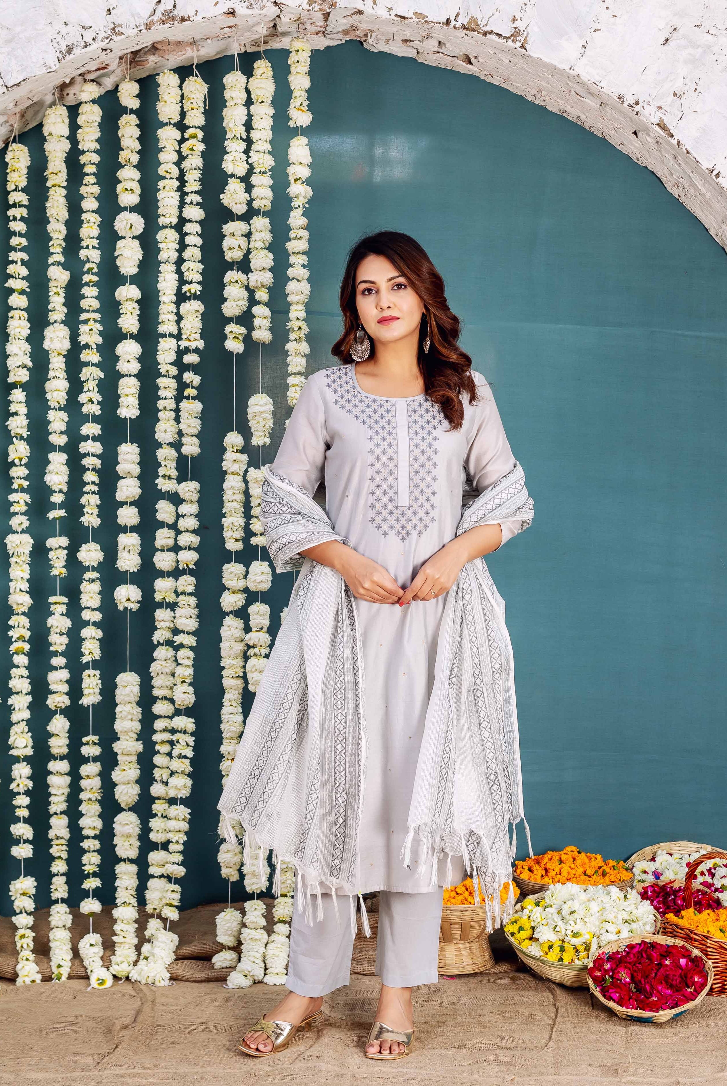 Model wears grey embroidered kurta with matching pants and hand-block-printed dupatta.