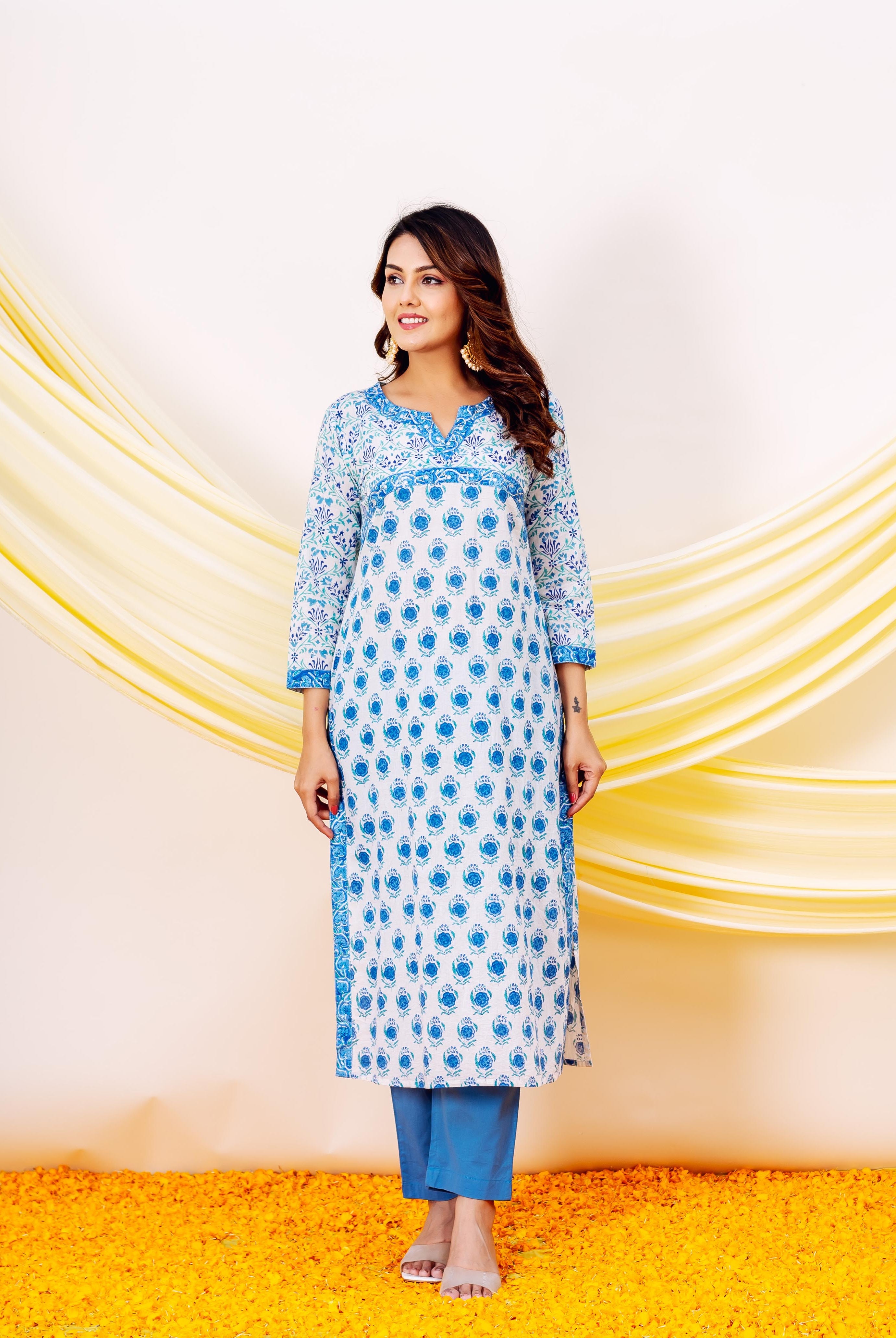 Smiling model wears a white and blue hand block printed cotton kurta set.
