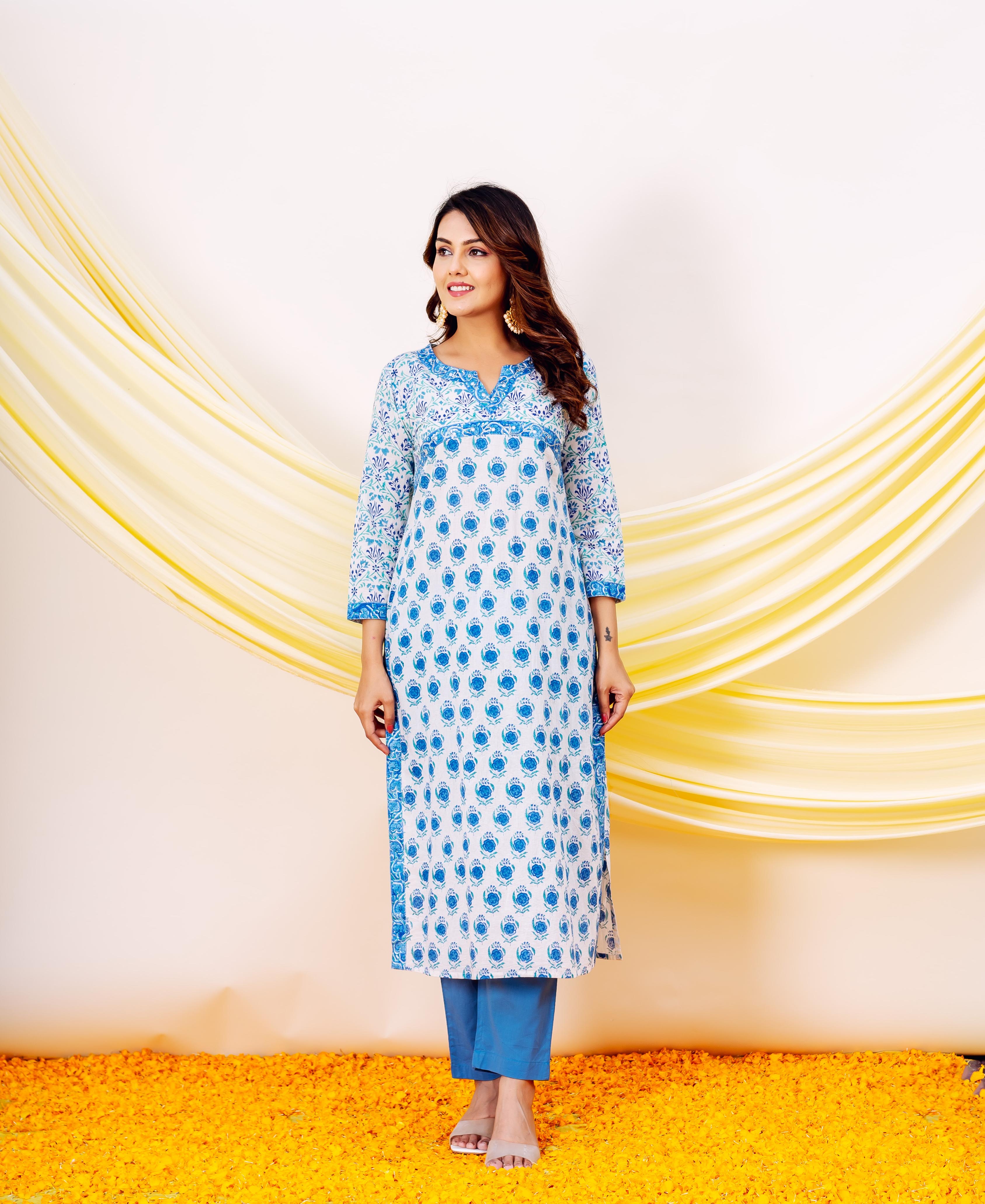 Smiling model wears a white and blue hand block printed cotton kurta set.