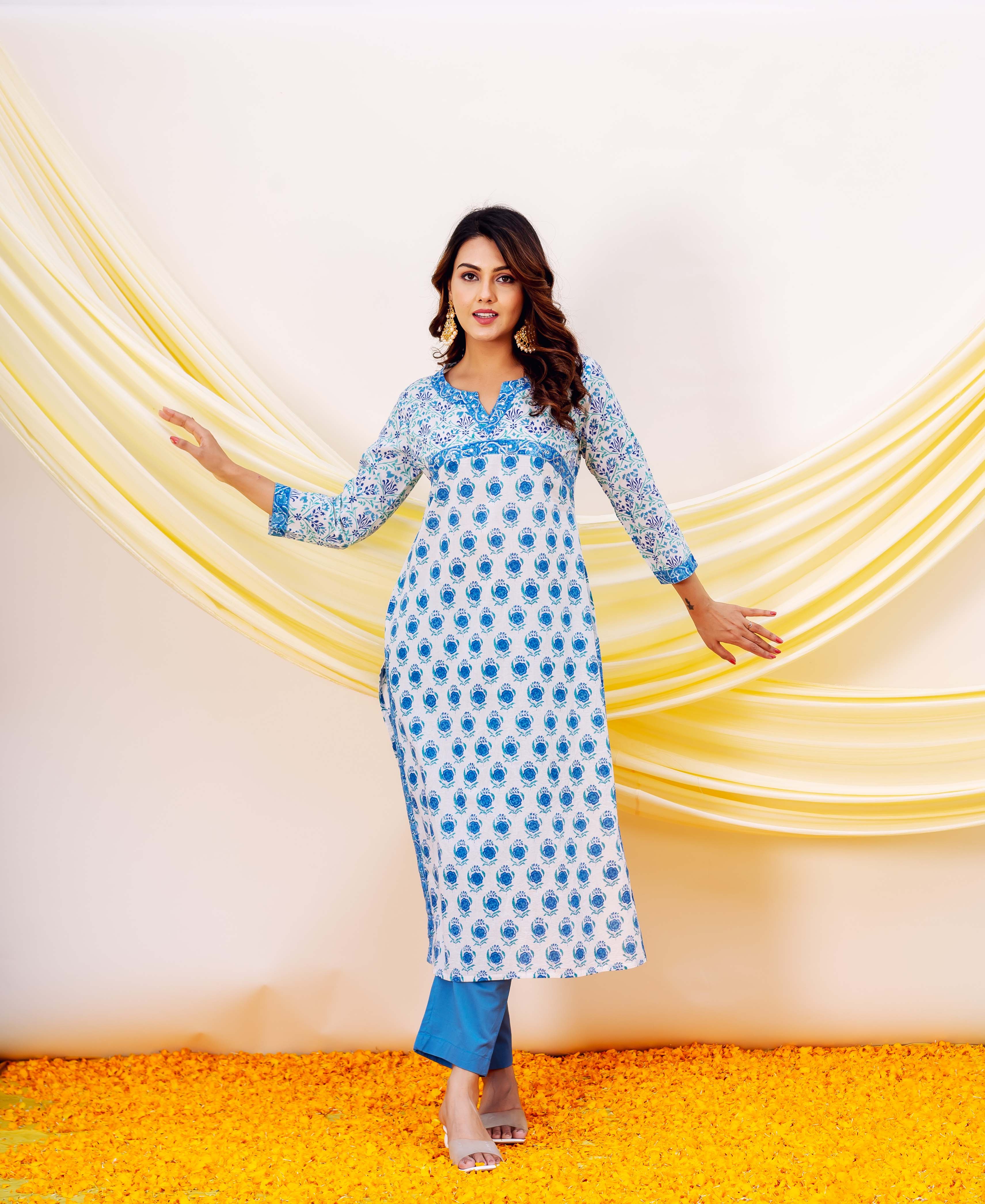 Woman wearing white and blue hand-block-printed cotton kurta with blue accents and patterned cuffs.