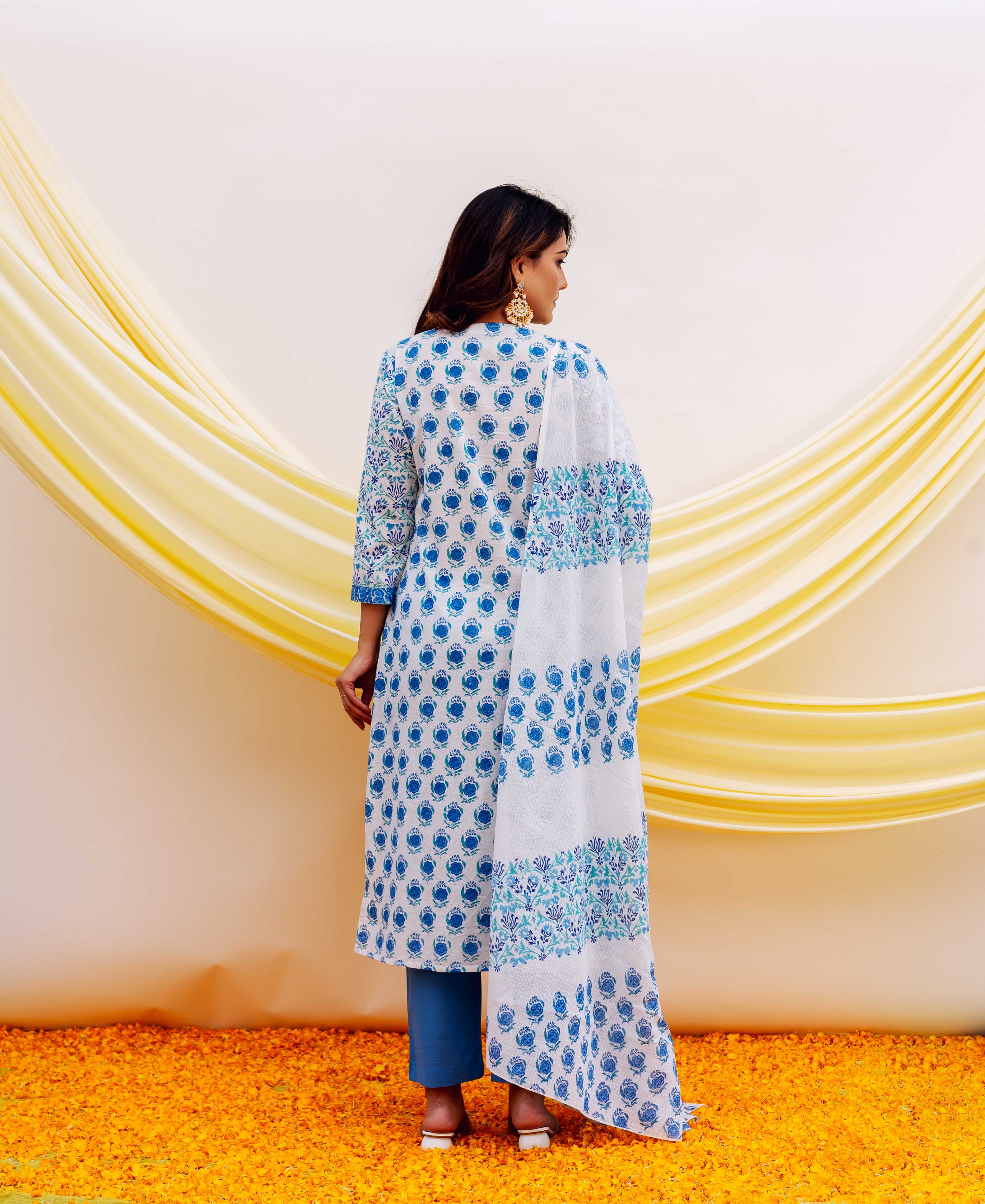 A woman wearing a white and blue hand-block-printed kurta with a floral pattern.