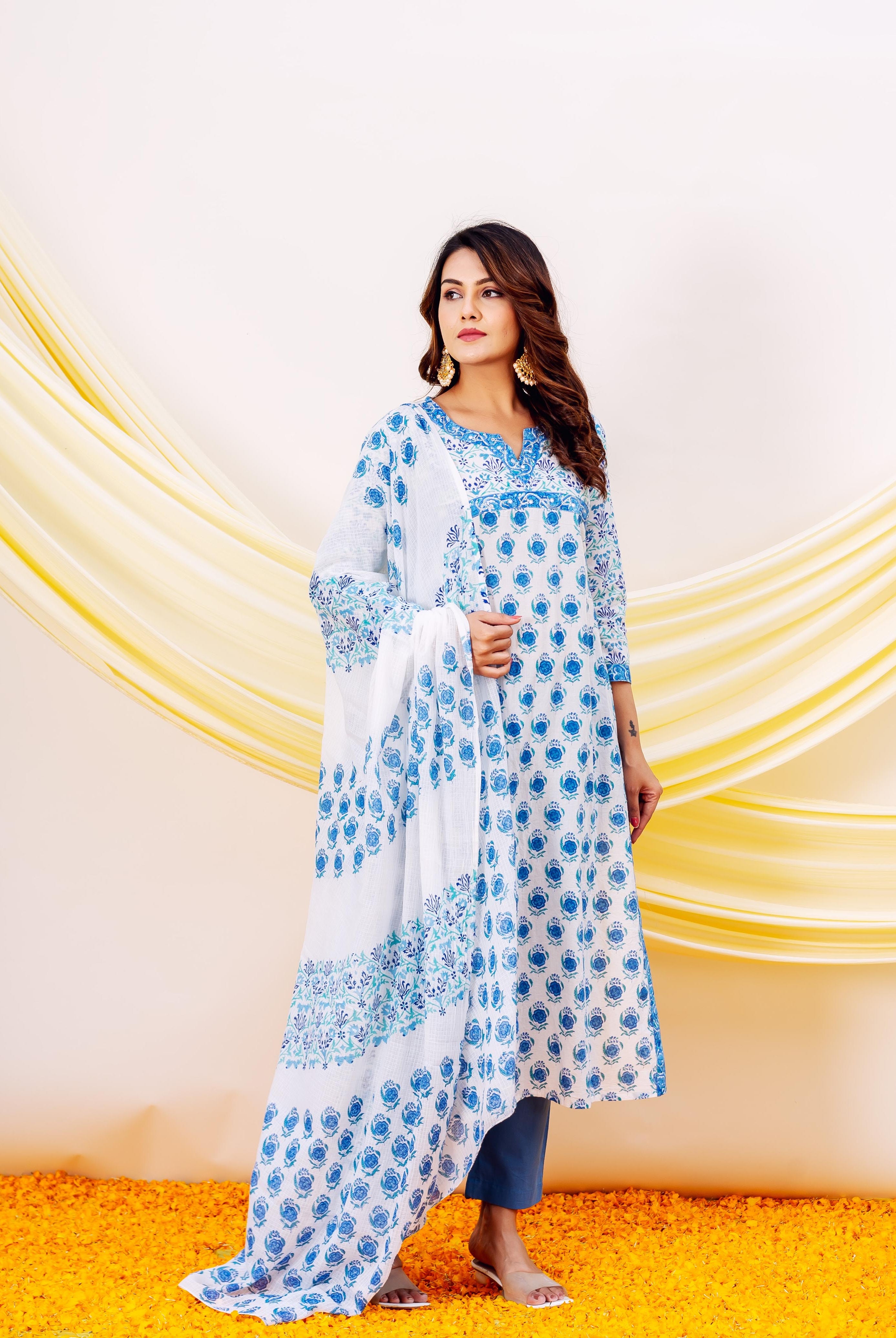 Full-length model in white and blue hand-block printed cotton kurta set with blue floral motifs.
