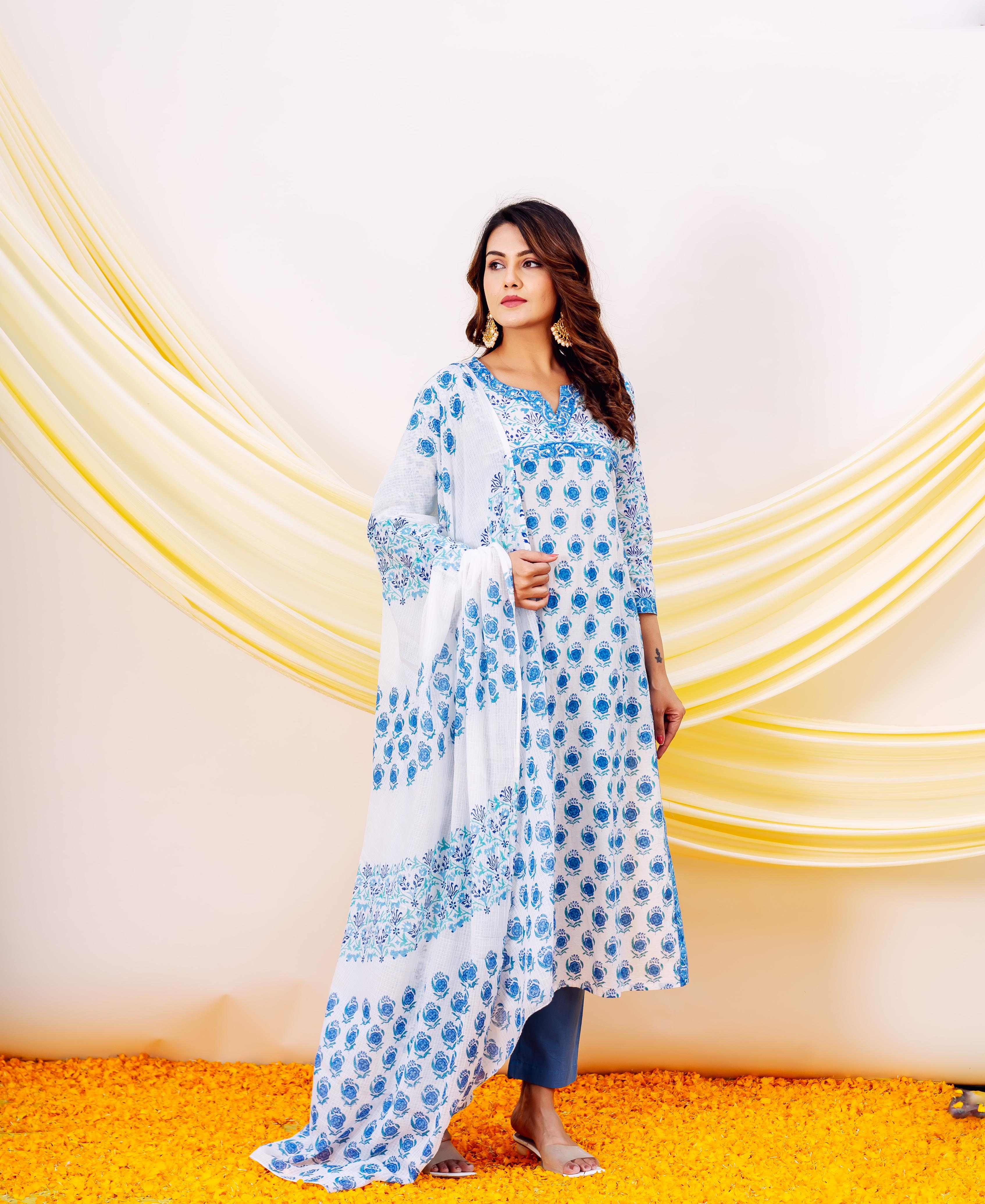 Full-length model in white and blue hand-block printed cotton kurta set with blue floral motifs.