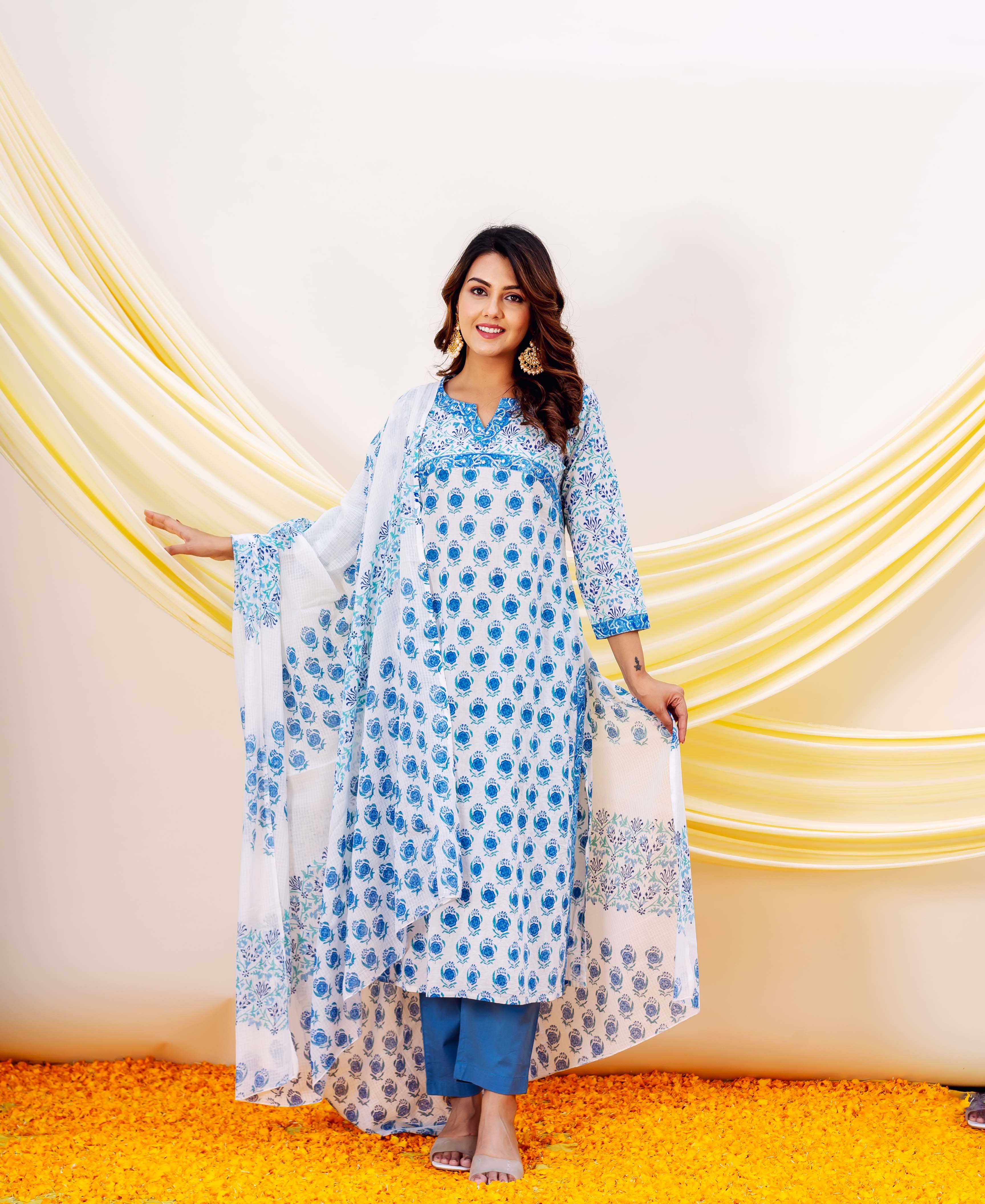 Woman in blue and white hand-block-printed cotton kurta with floral patterns and yellow drapes.