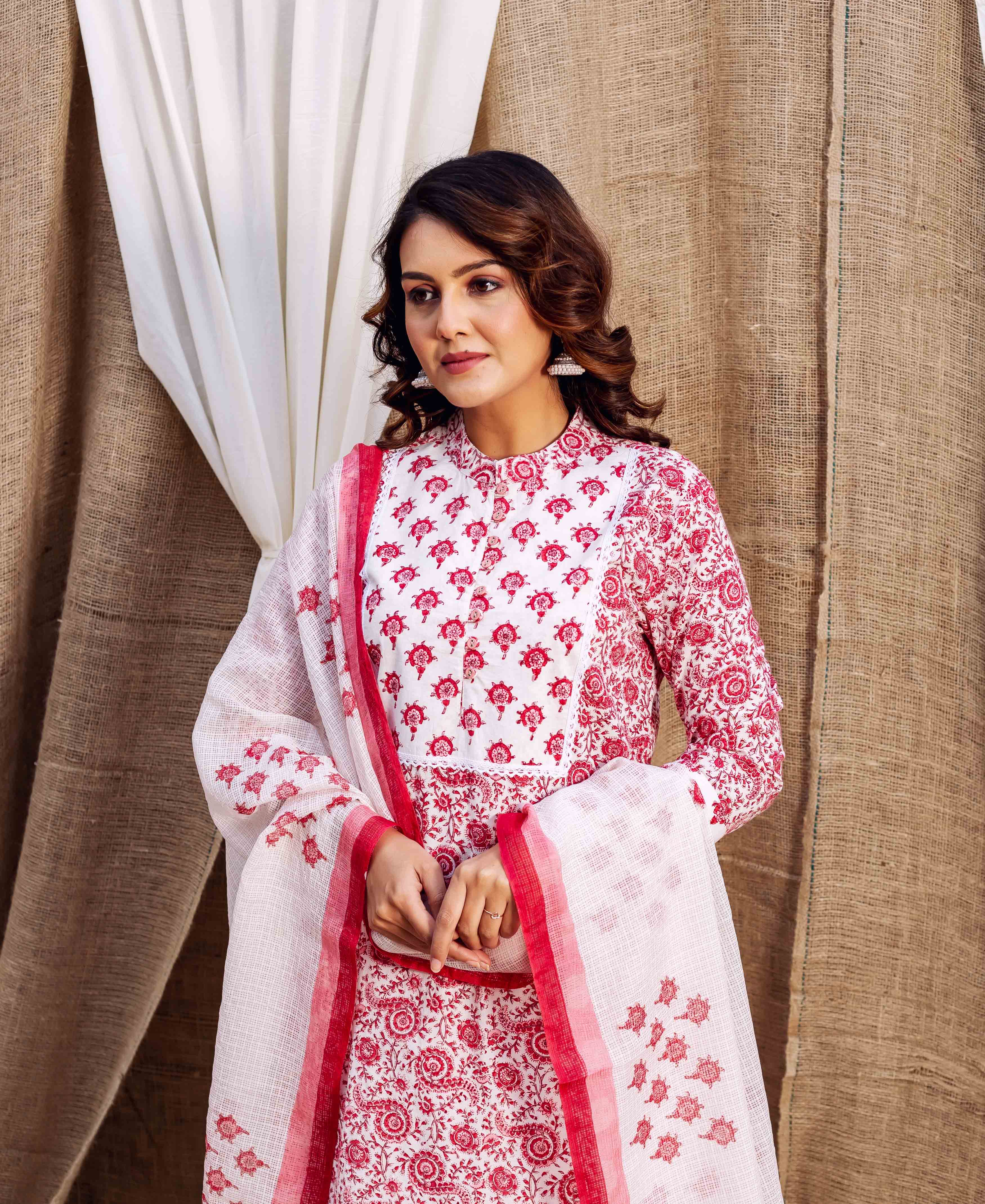 Model poses in a red and white hand-block printed kurta and matching sheer dupatta.