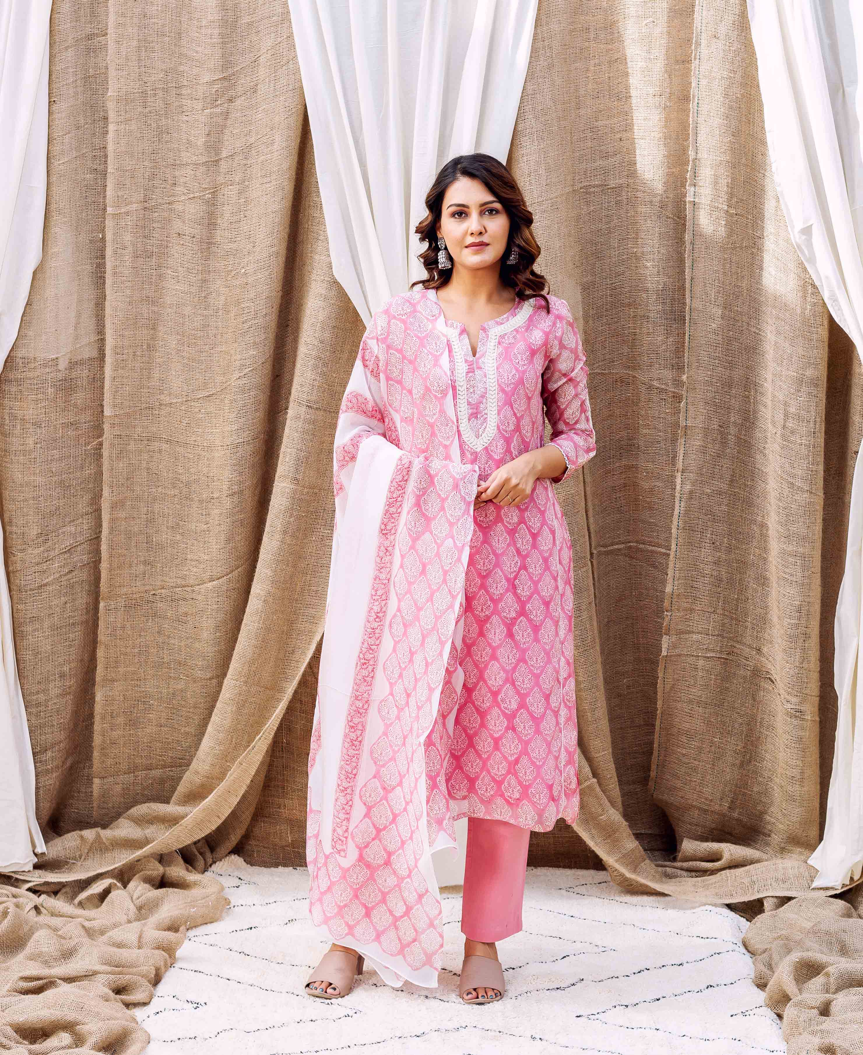 Full-length photo of a woman in a pink ethnic suit with white hand-block print.