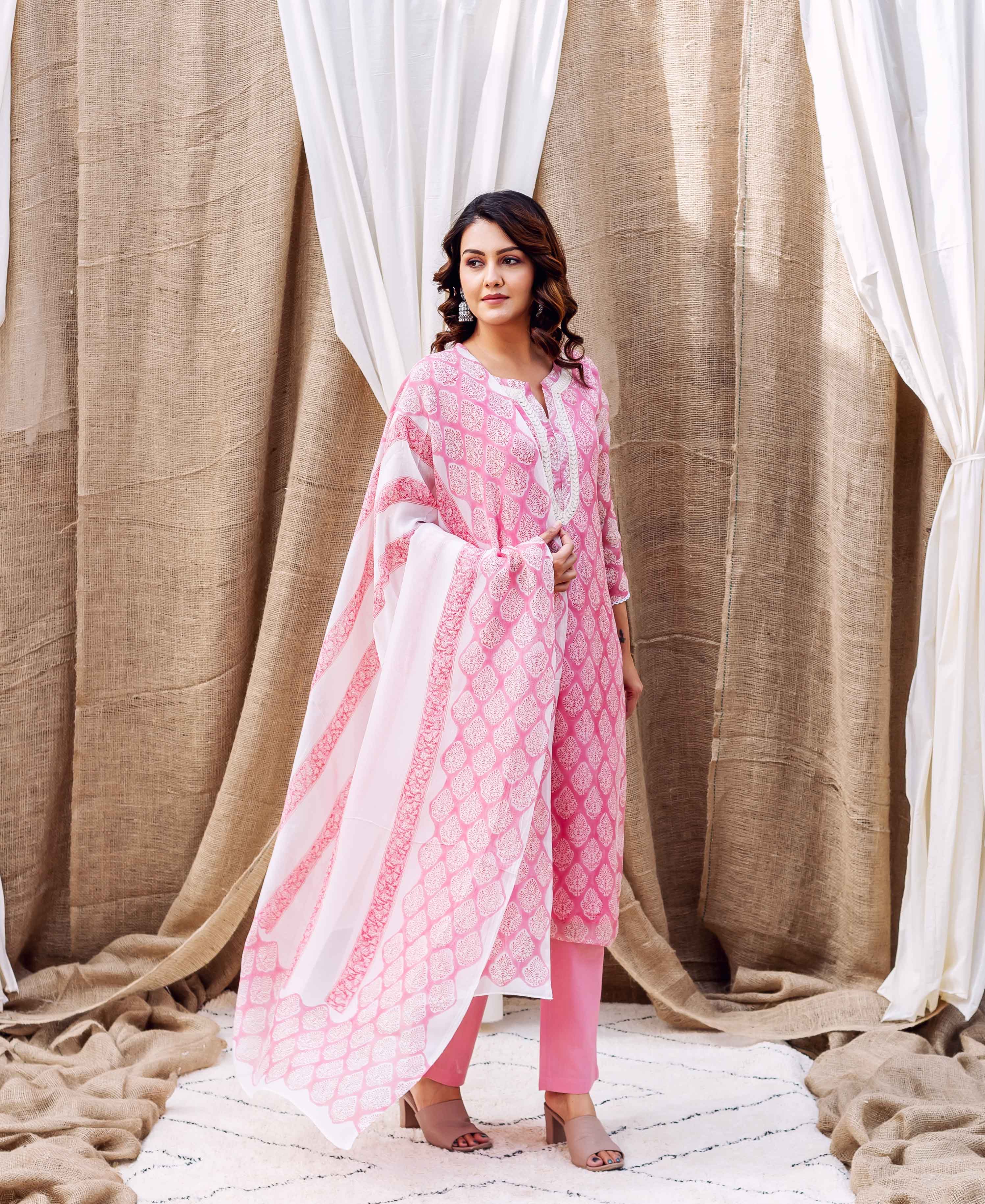 Female model in a white and pink hand block printed organza dupatta and matching suit.
