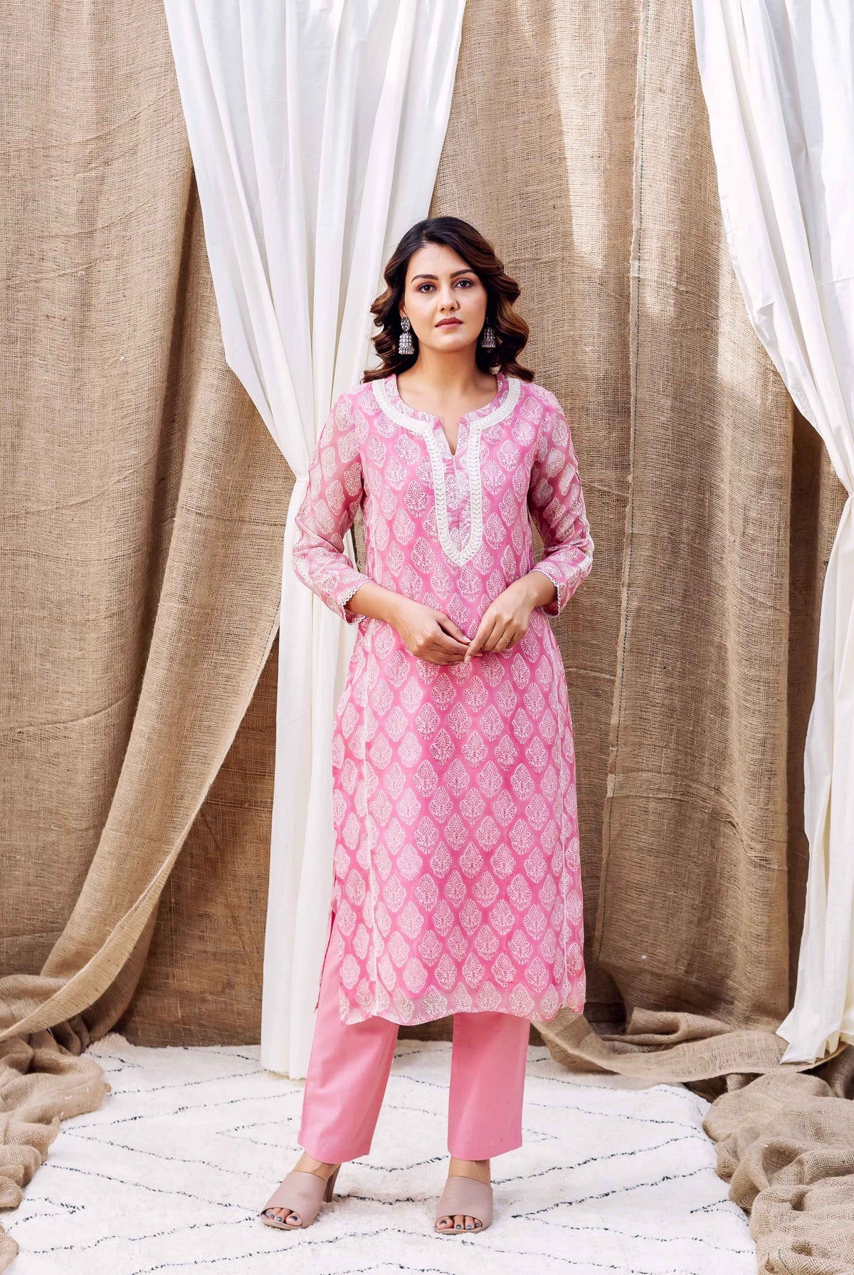 Blush pink hand-block-printed organza kurta with white print and matching pants worn by a model.