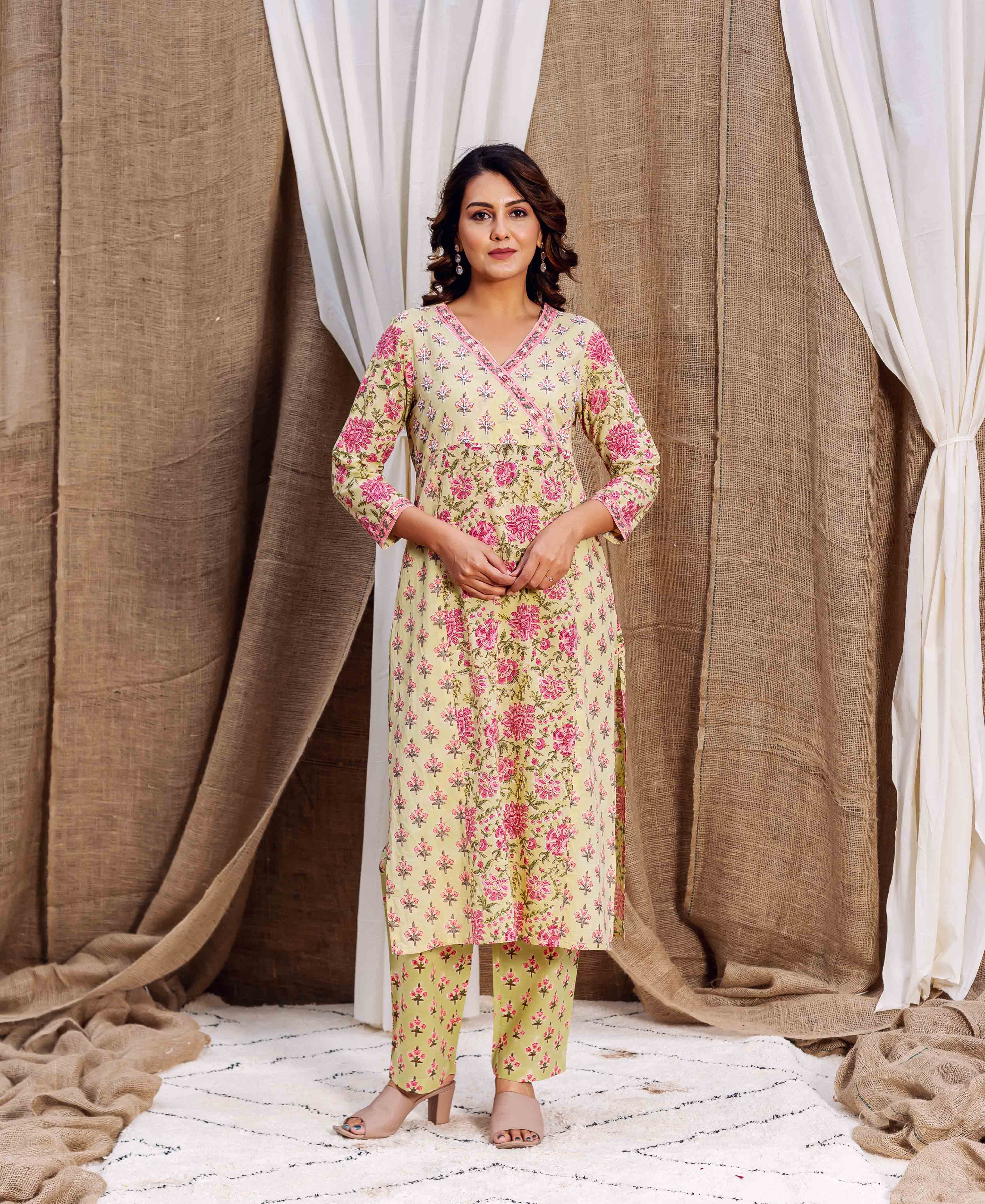 Full-length model wears light green kurta set with pink floral block print.