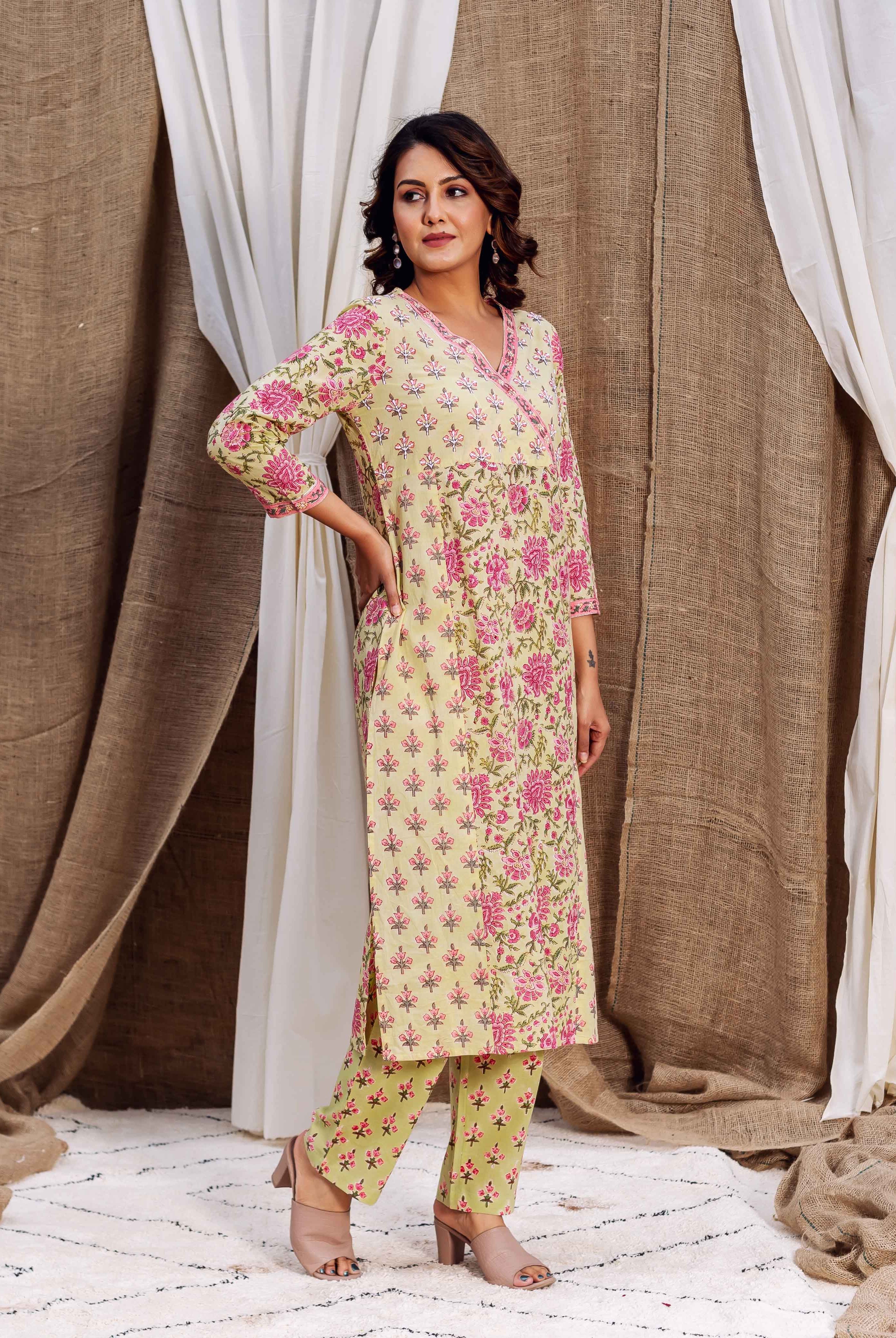 Full-length model in a yellowish-green kurta set with pink floral hand-block print.