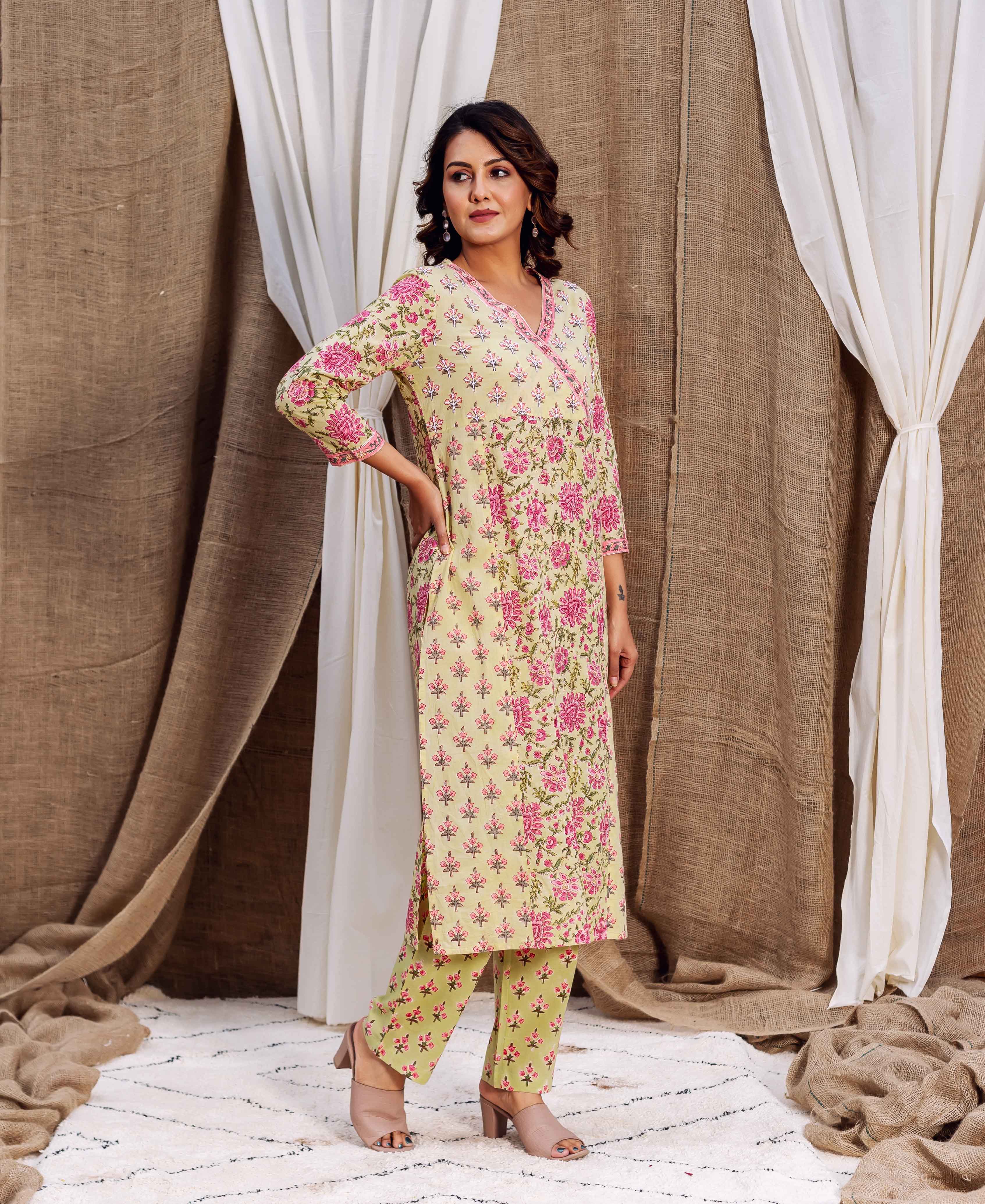 Full-length model in a yellowish-green kurta set with pink floral hand-block print.