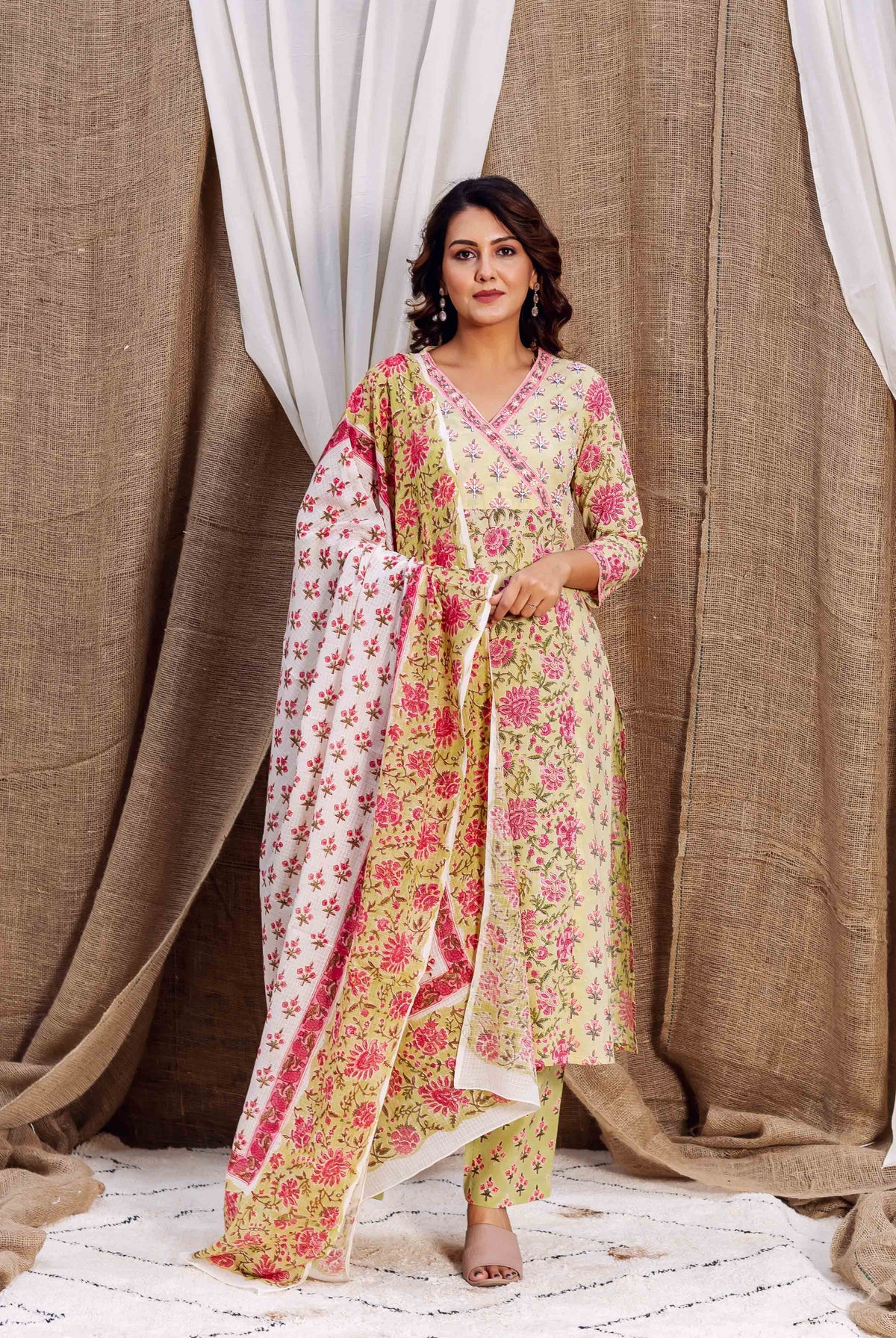 Woman in a yellow and pink floral multi-print kurta set with coordinating dupatta.