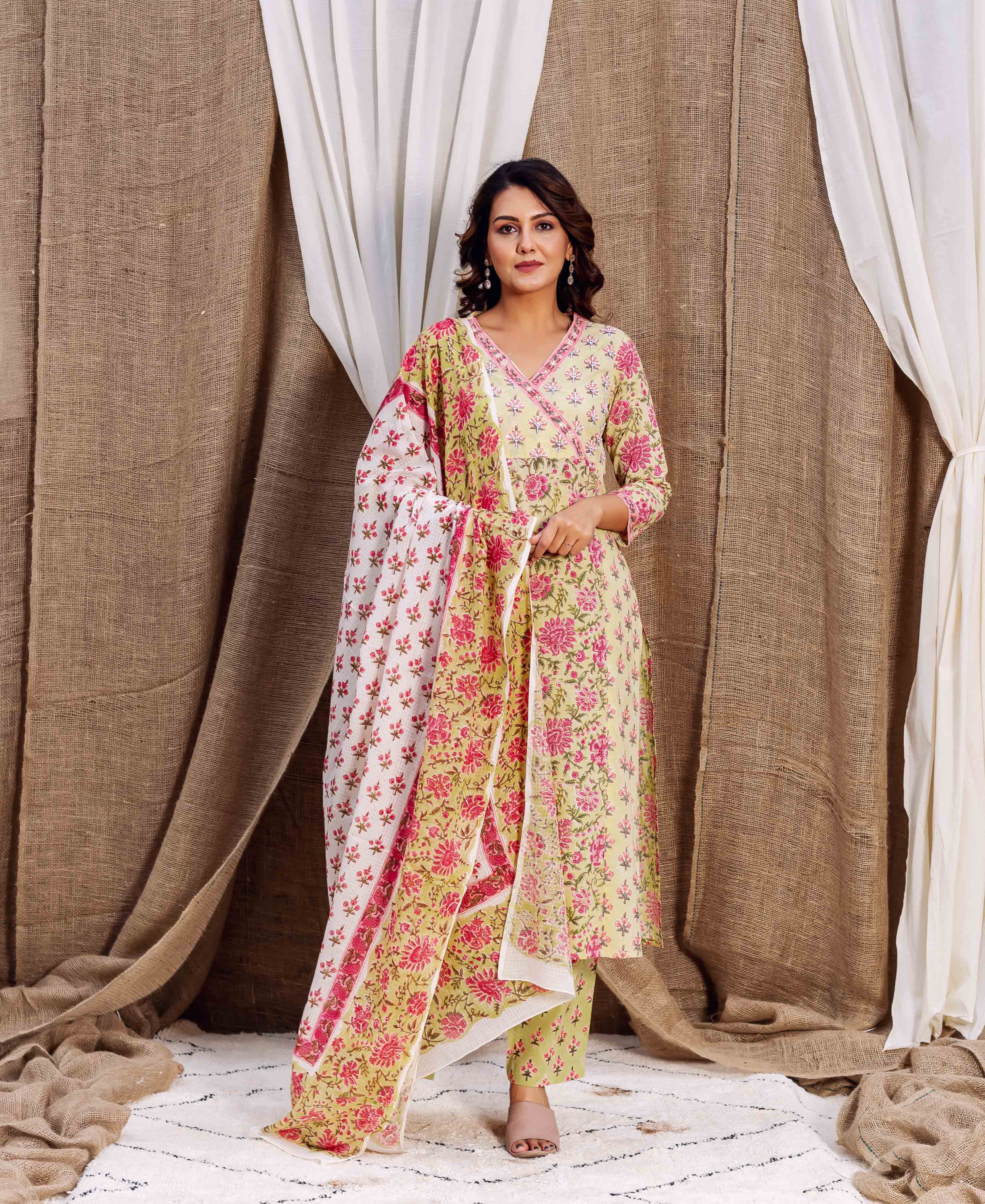 Woman in a yellow and pink floral multi-print kurta set with coordinating dupatta.
