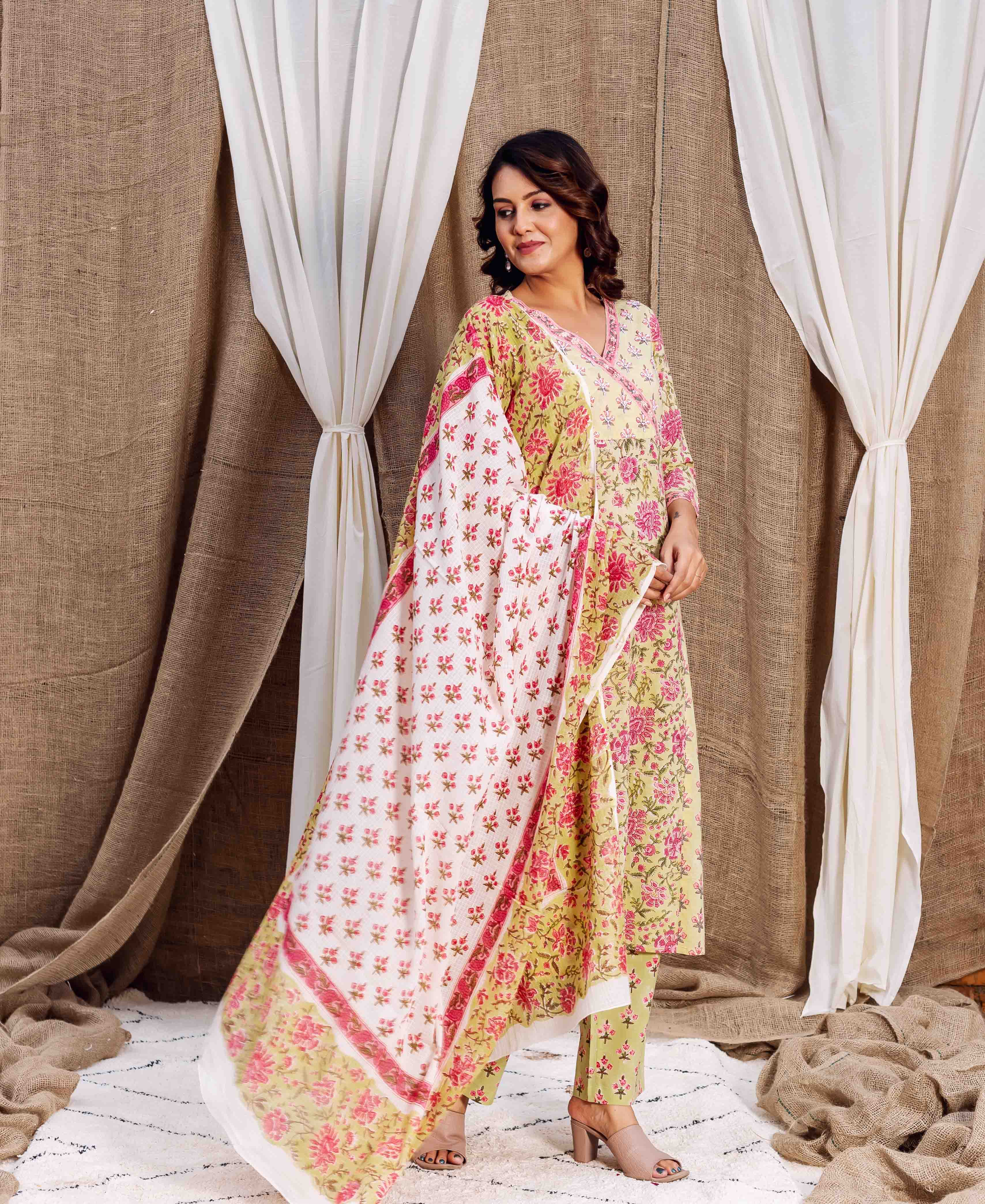 A woman models a yellow floral hand-block-printed dupatta with pink accents.