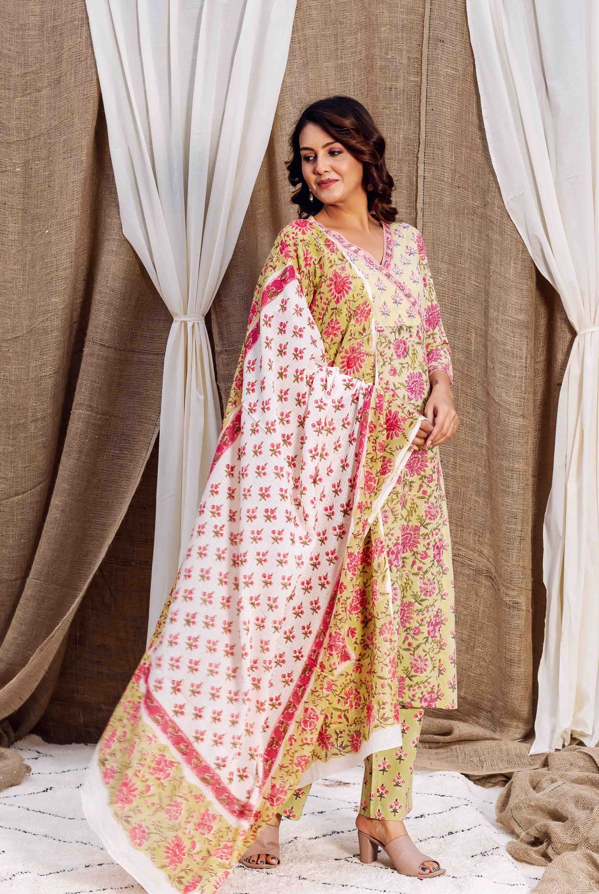 Full view: model in light green and pink floral kurta set with printed dupatta.
