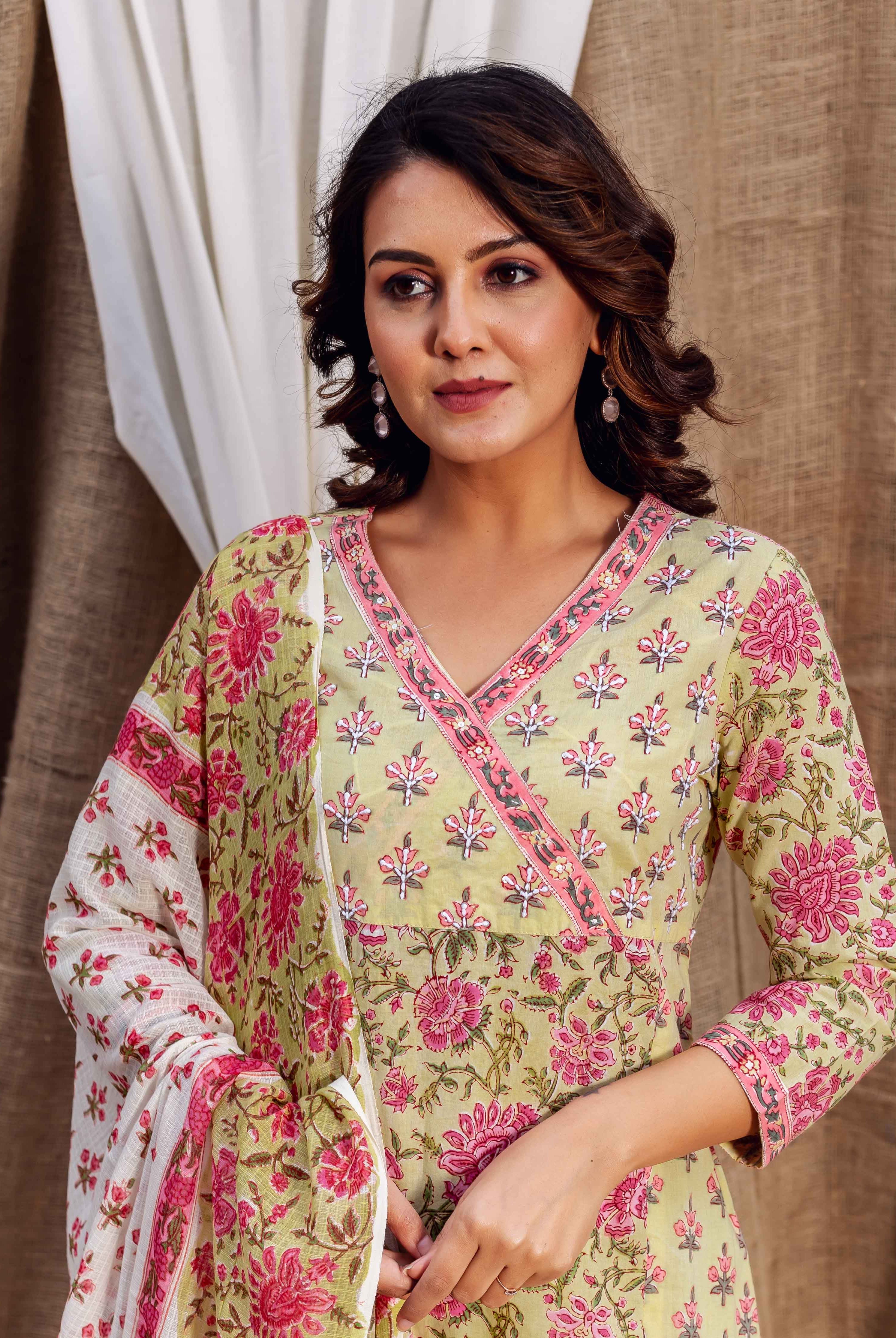 Model in a light green, pink floral hand-block printed kurta and matching dupatta.