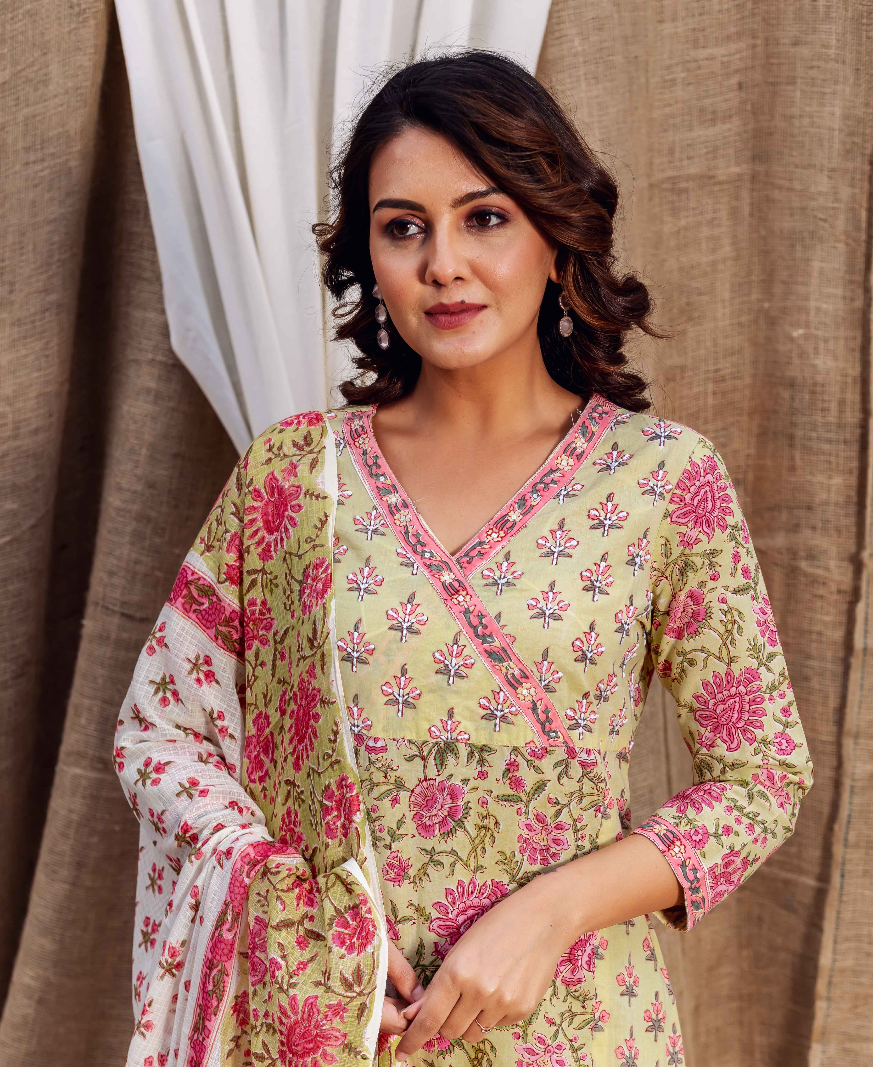 Model in a light green, pink floral hand-block printed kurta and matching dupatta.