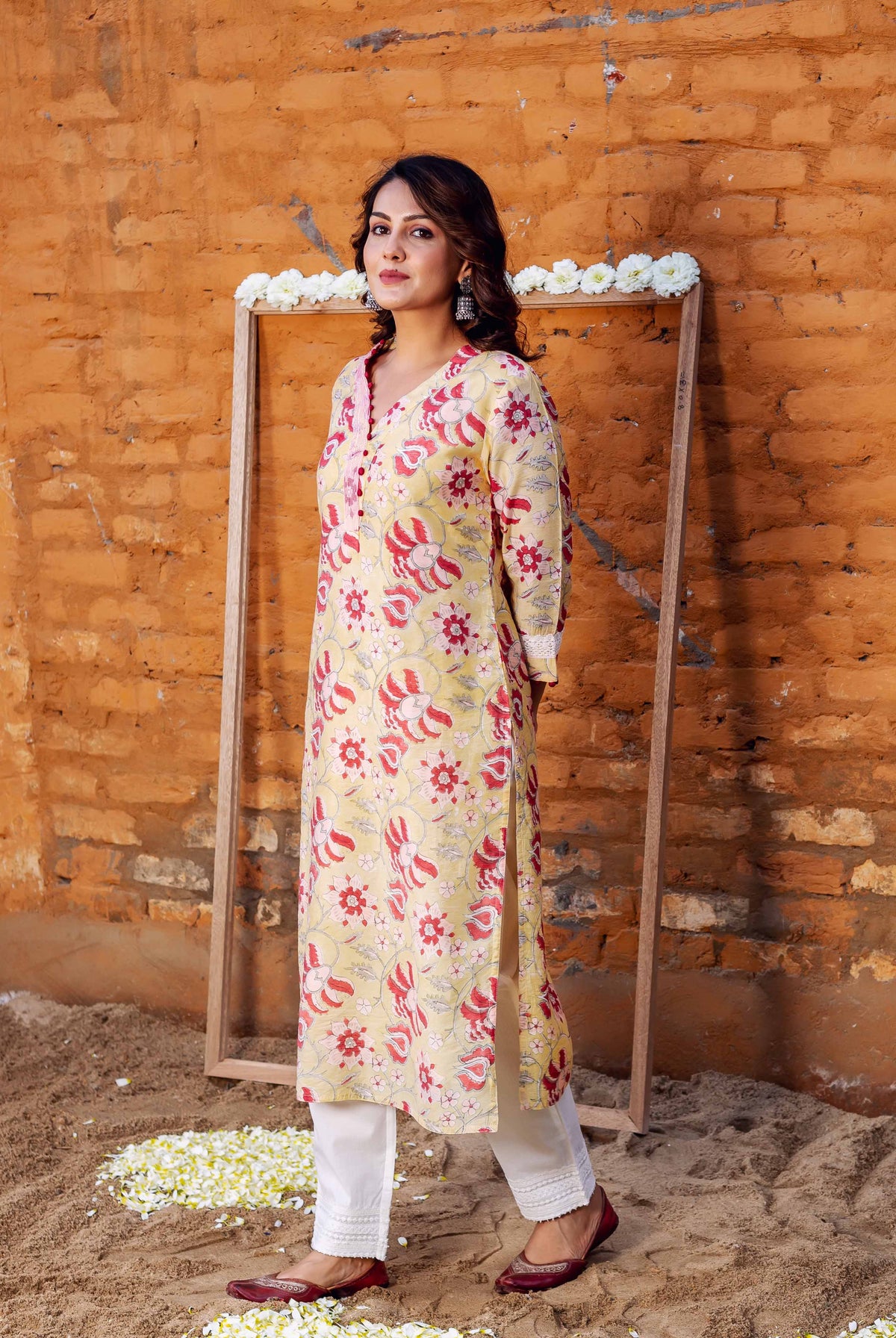 Full-length model wearing yellow red floral block-print kurta with white embroidered pants.