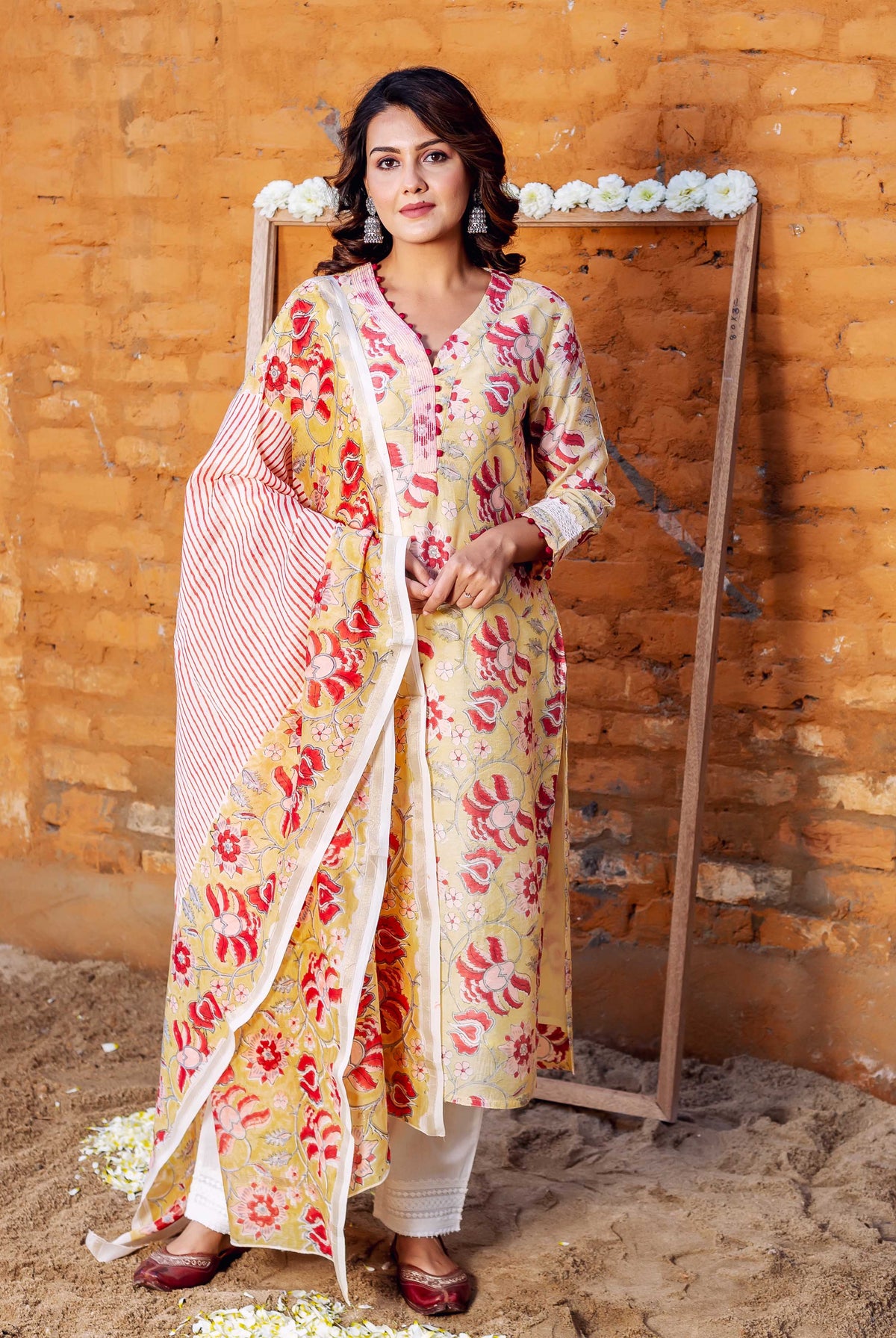 On a model, straight-on view of yellow-red floral Chanderi kurta set with striped dupatta.