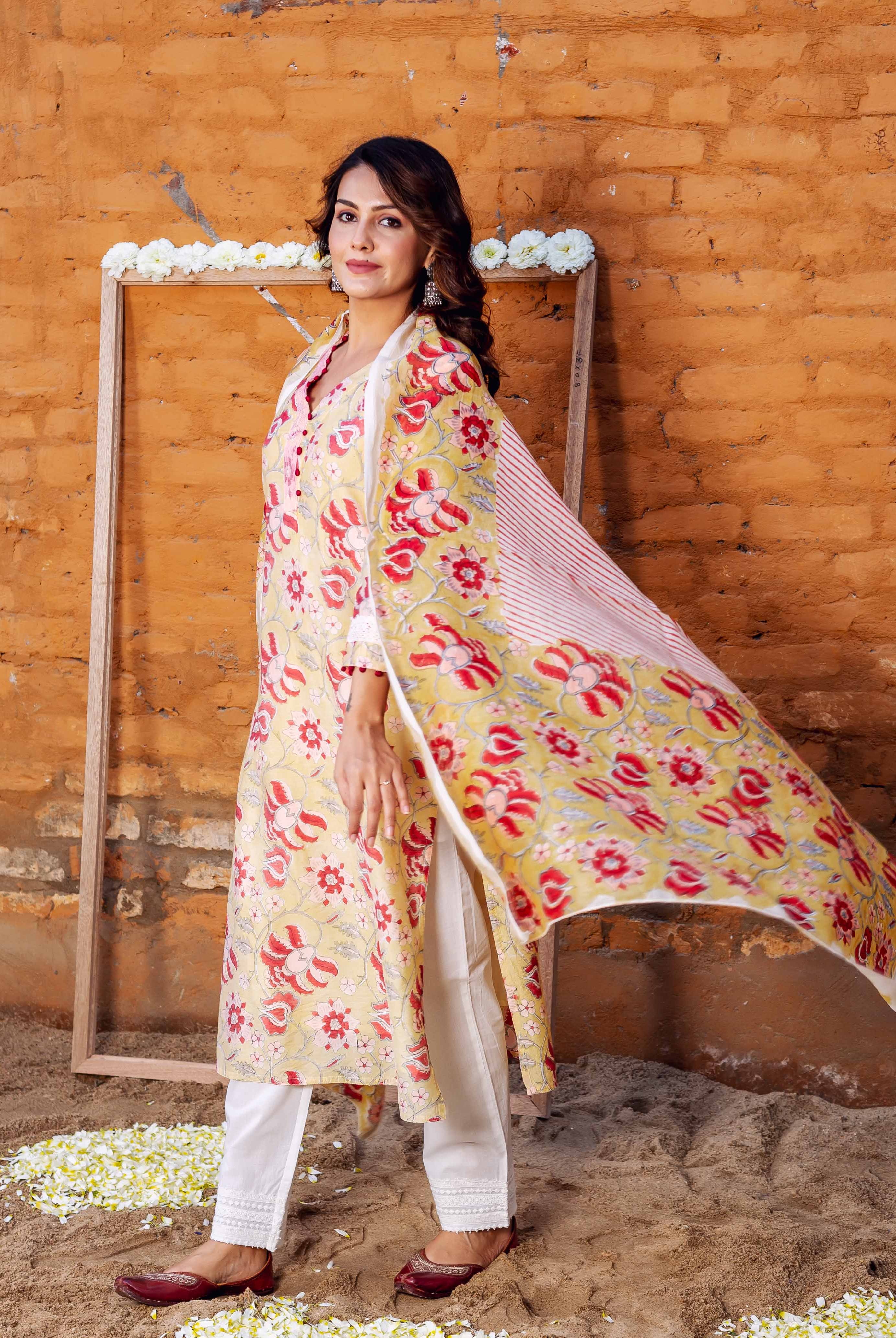 Full-length model in a yellow hand-block printed floral kurta, white pants, and flowing dupatta.
