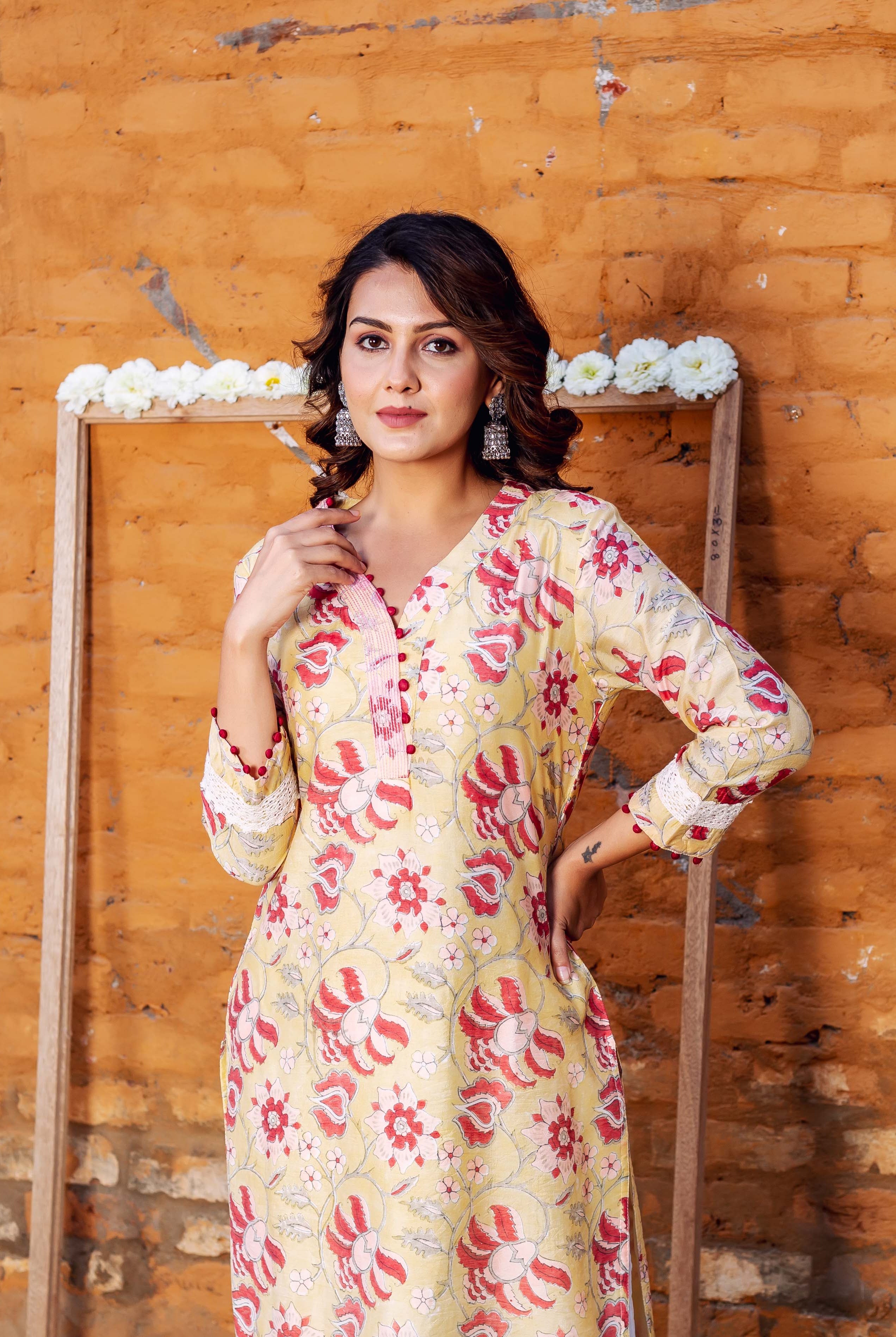 Model wearing a sunlit yellow Chanderi kurta with misprint red and pink hand-block blossom print.