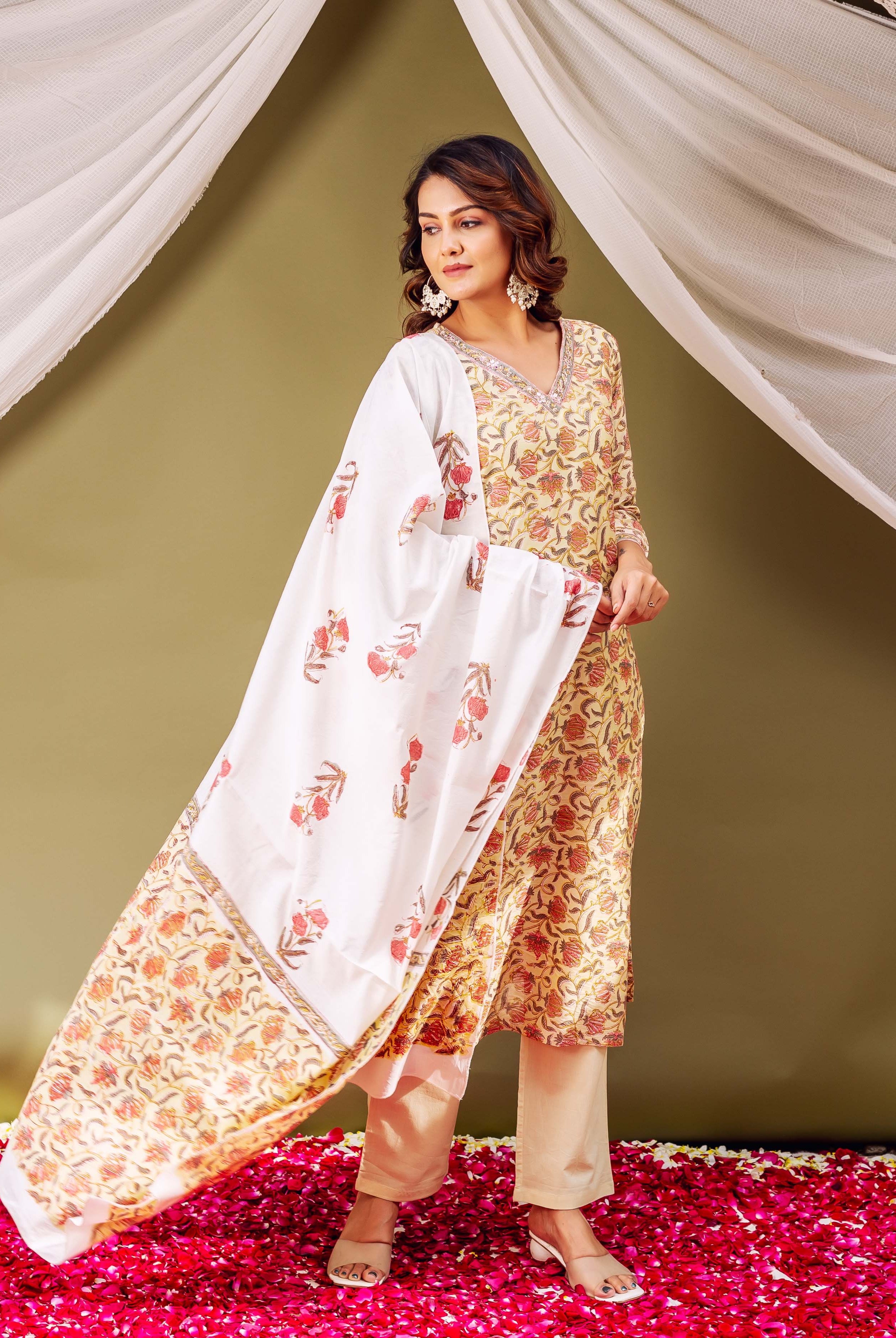 A woman in a green and white floral print kurta with a matching dupatta.