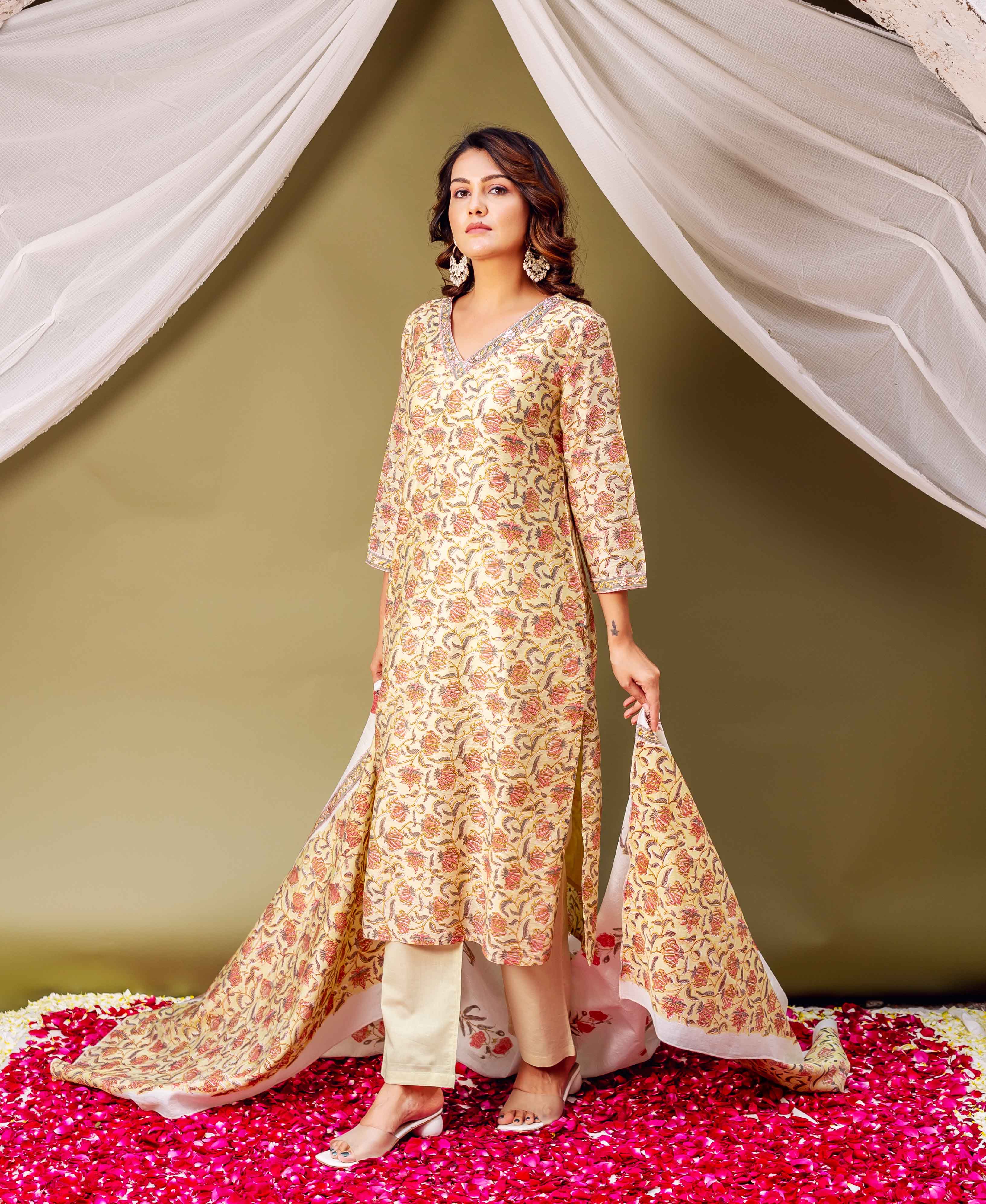A woman in a yellow floral print chanderi dupatta and matching kurta.