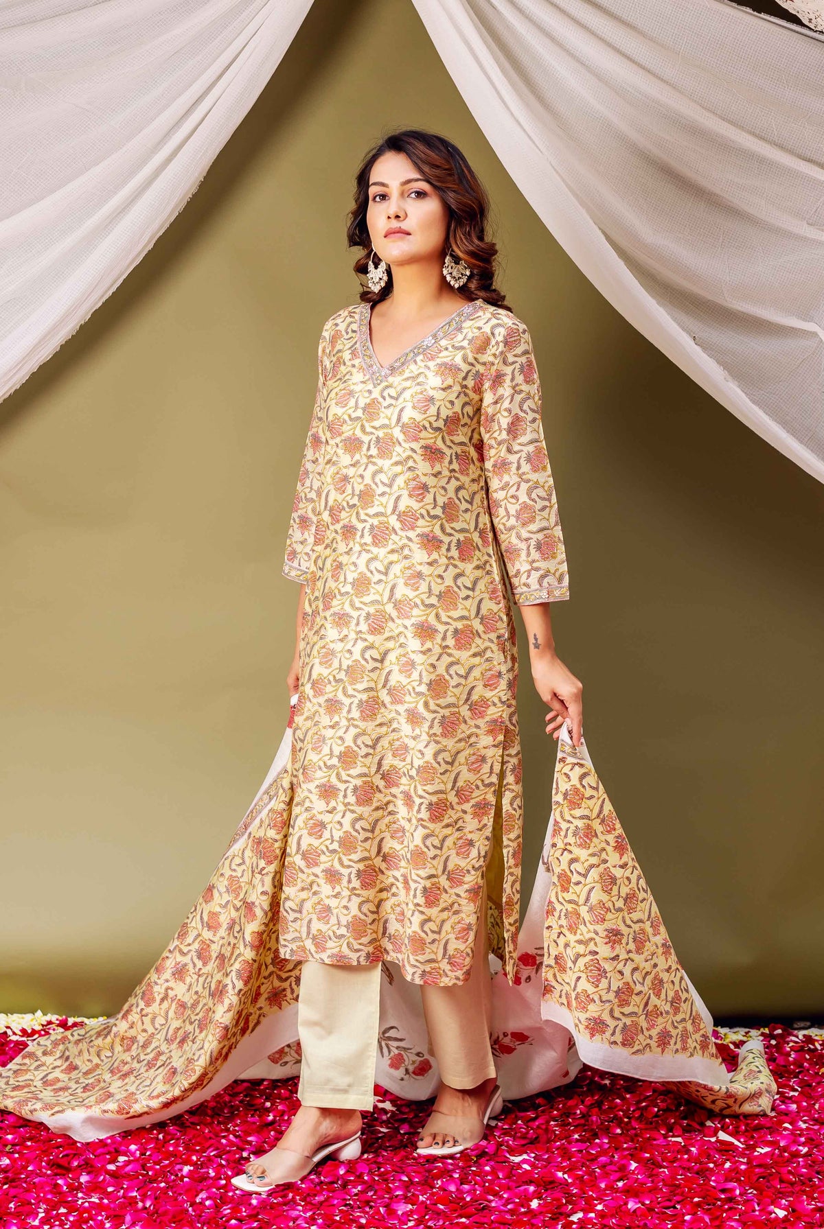 A woman in a green floral block-print kurta with matching dupatta.