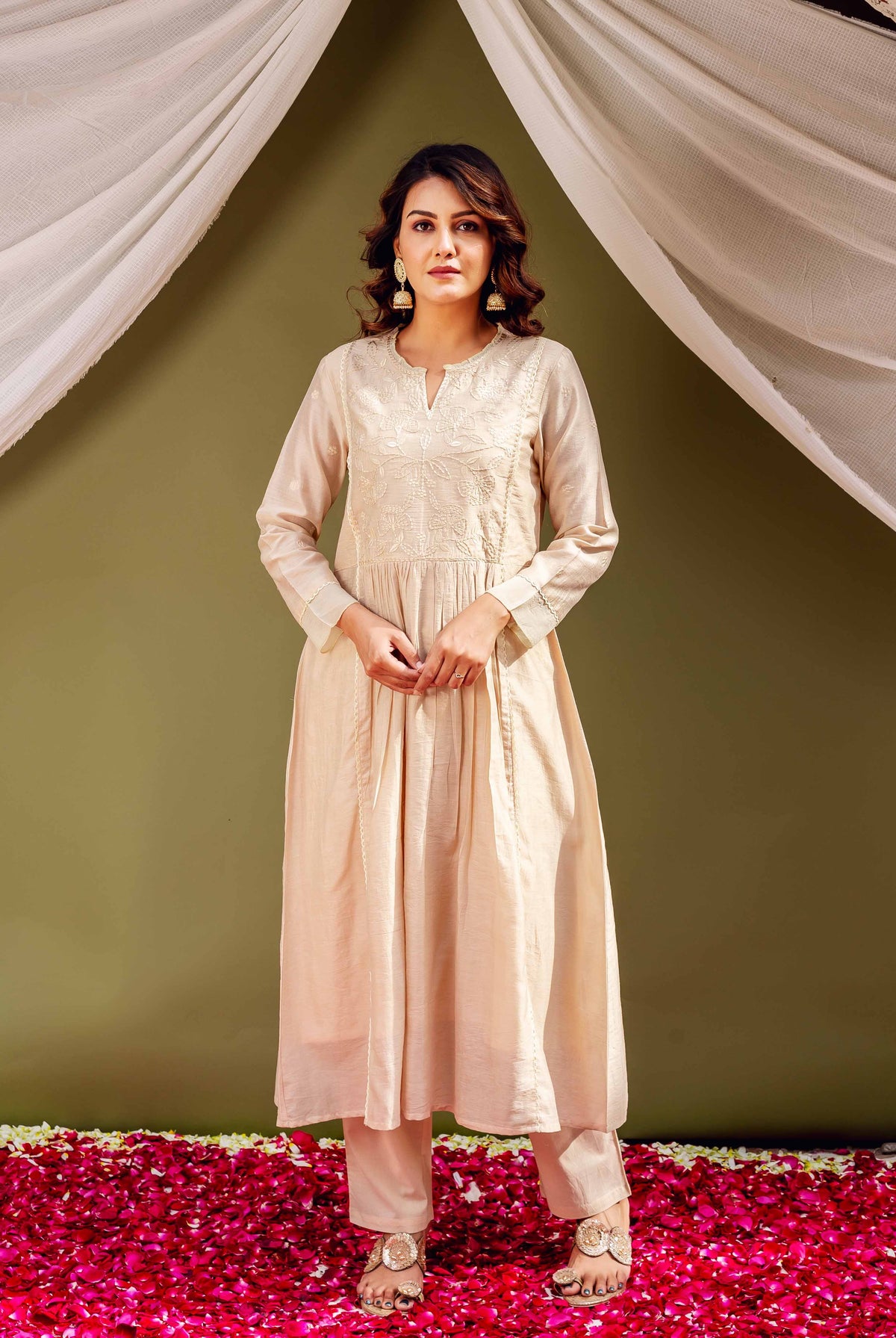 Full-length model wears sandstone Chanderi kurta and pants with intricate white embroidery.