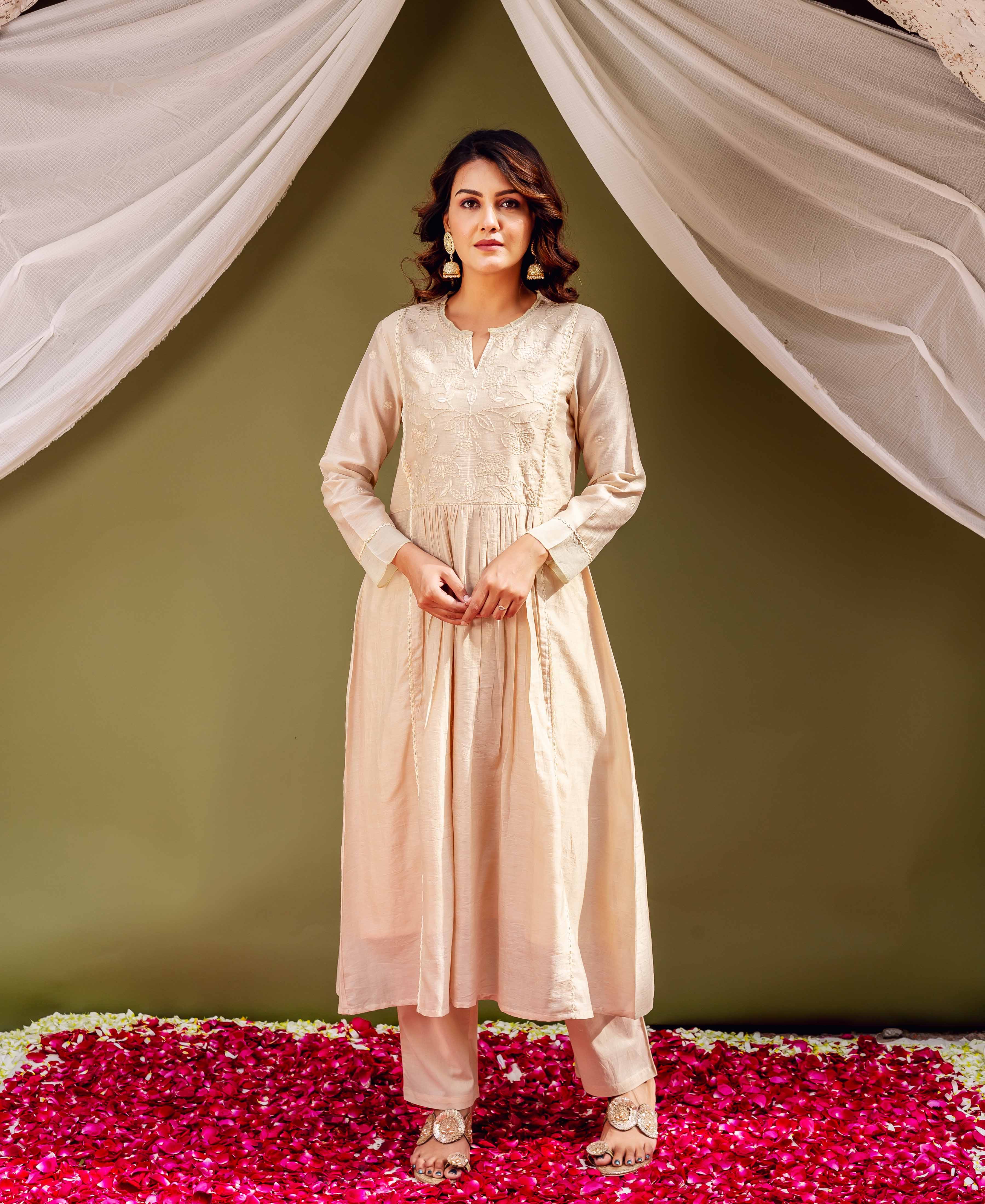 Full-length model wears sandstone Chanderi kurta and pants with intricate white embroidery.