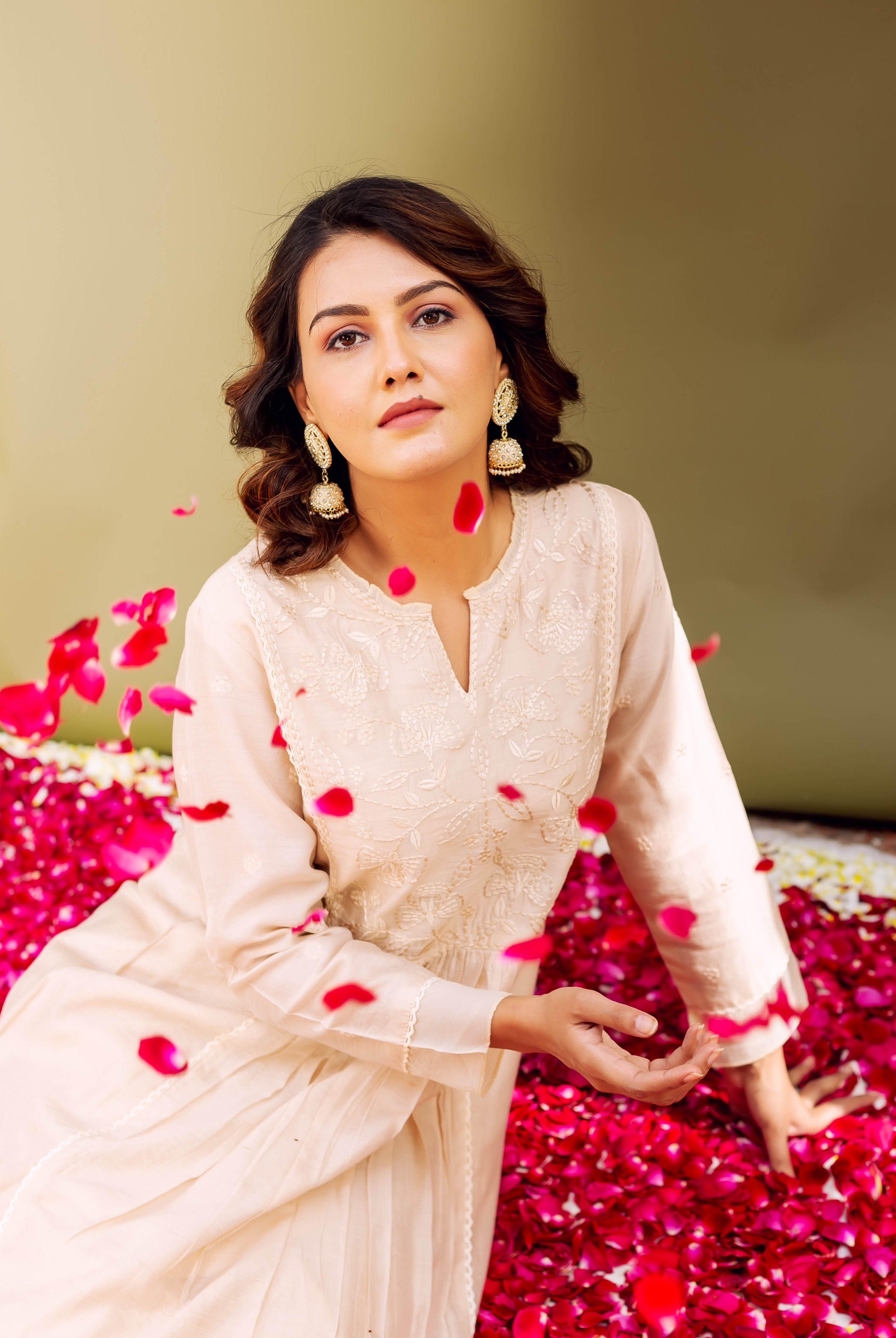 Seated model in light sandstone chanderi kurta featuring subtle ethnic patterns.