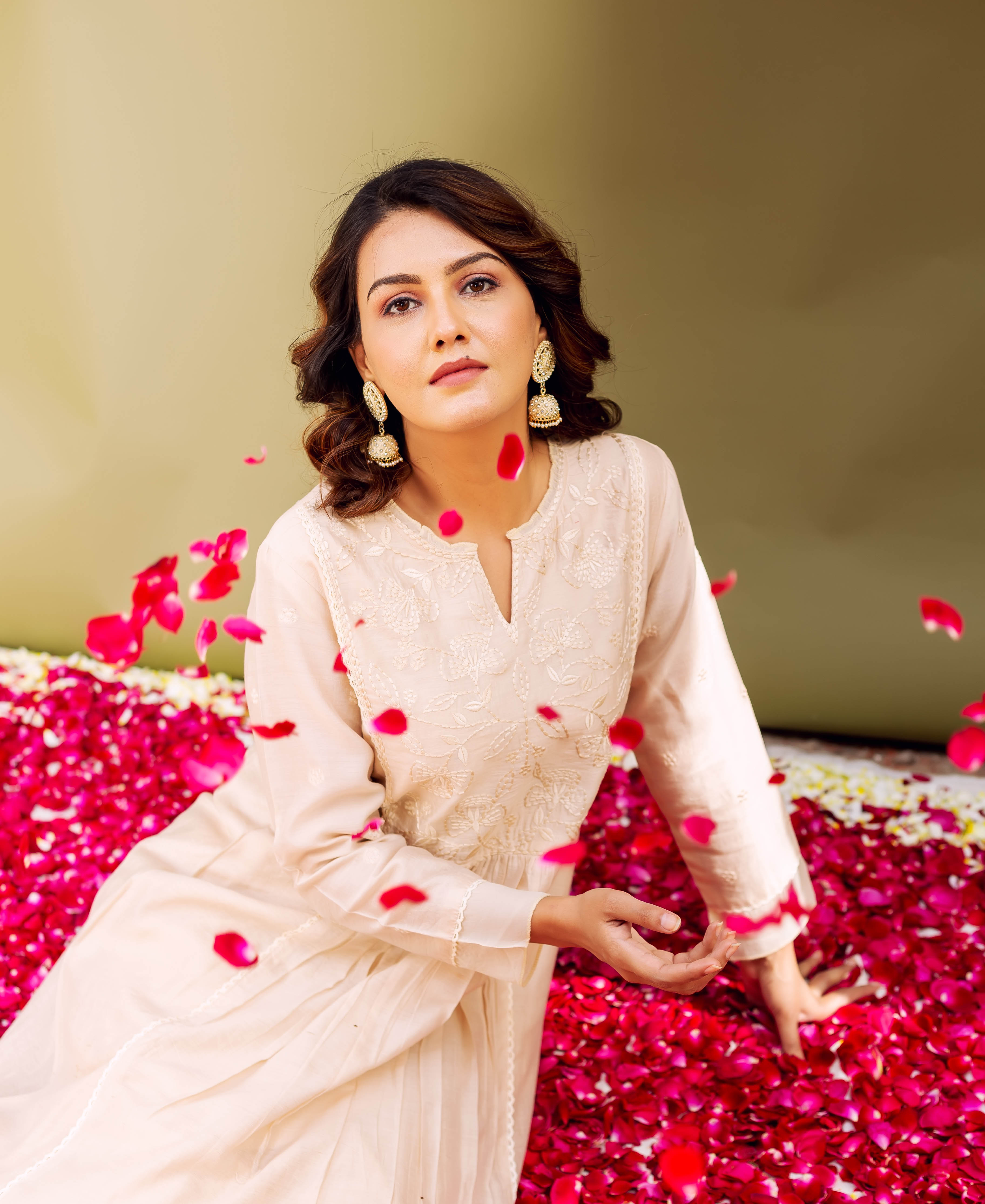 Seated model in light sandstone chanderi kurta featuring subtle ethnic patterns.