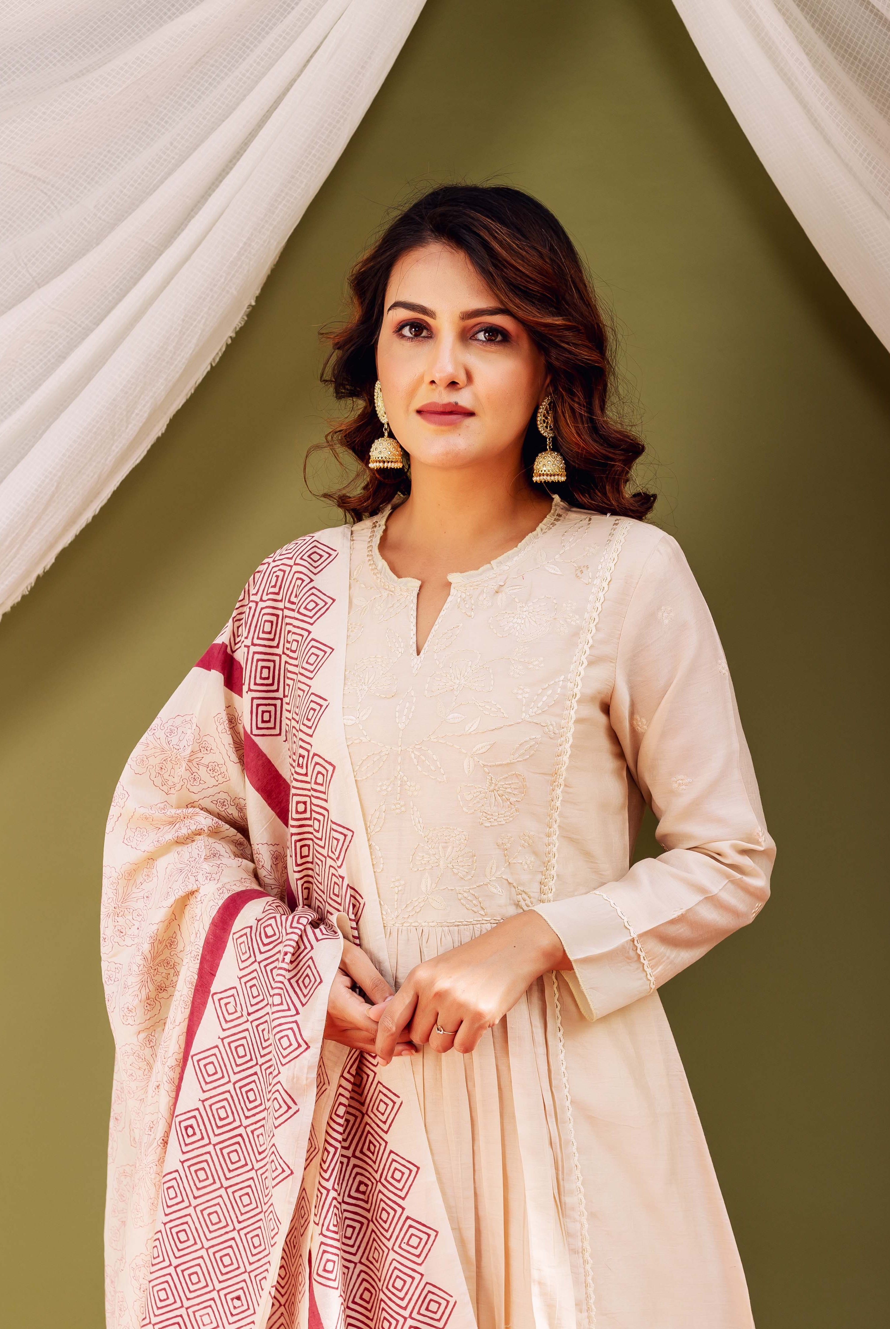Model in sandstone Chanderi kurta with embroidery and red geometric block-printed dupatta.
