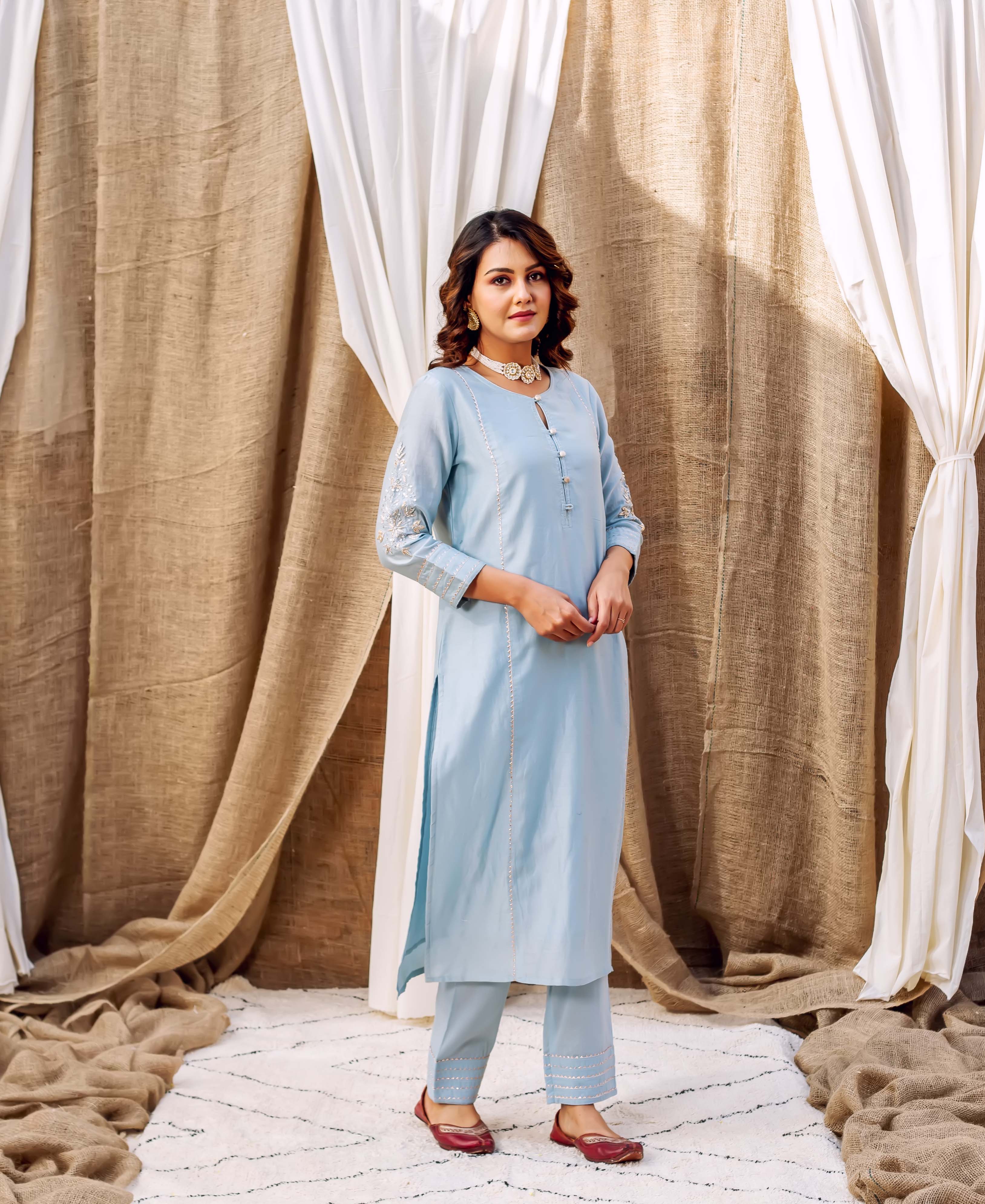 Front view of model in an azure ethnic kurta set with delicate embroidery on sleeves.