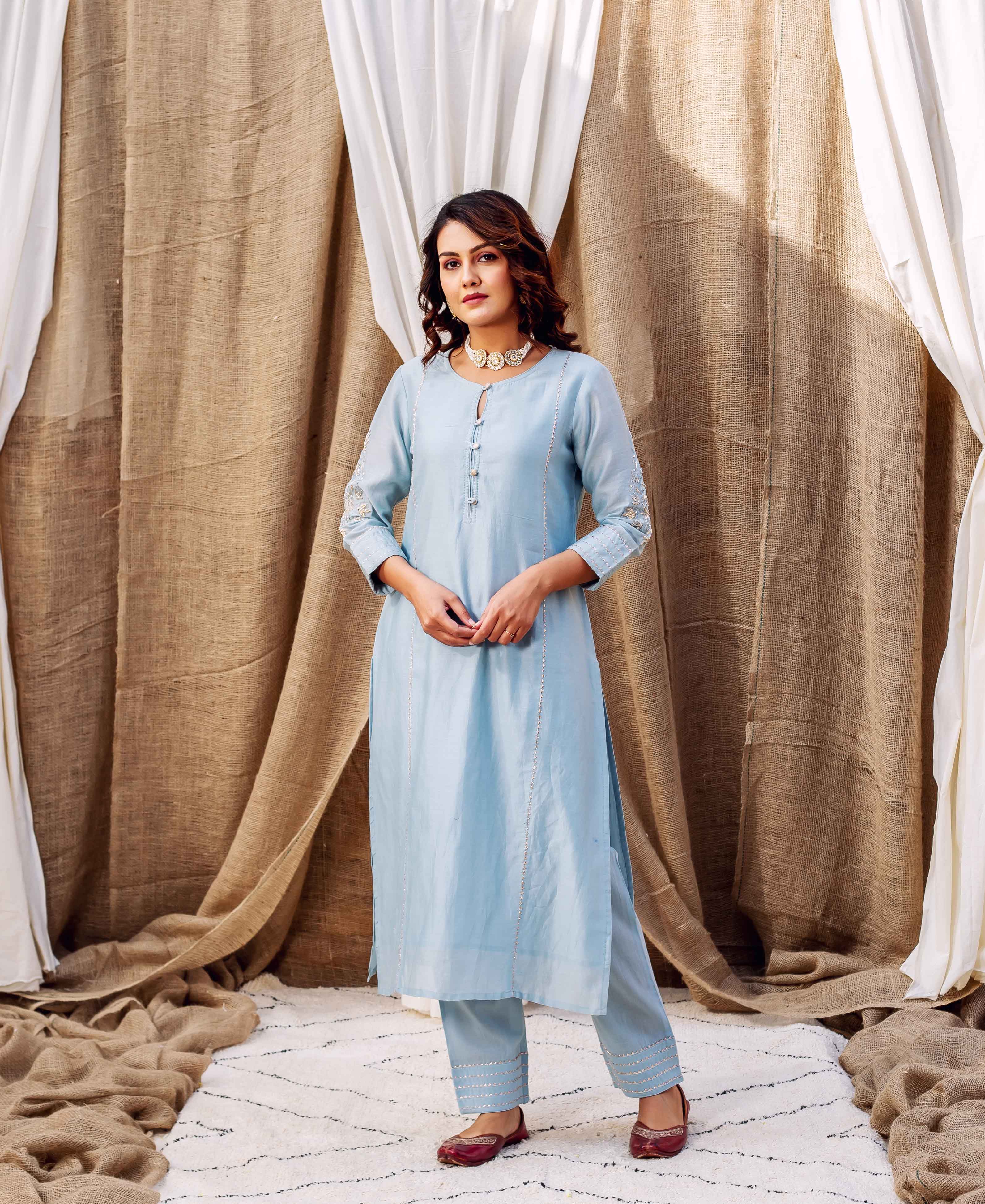 Front view of azure silk chanderi kurta set on model with subtle ethnic embroidery.